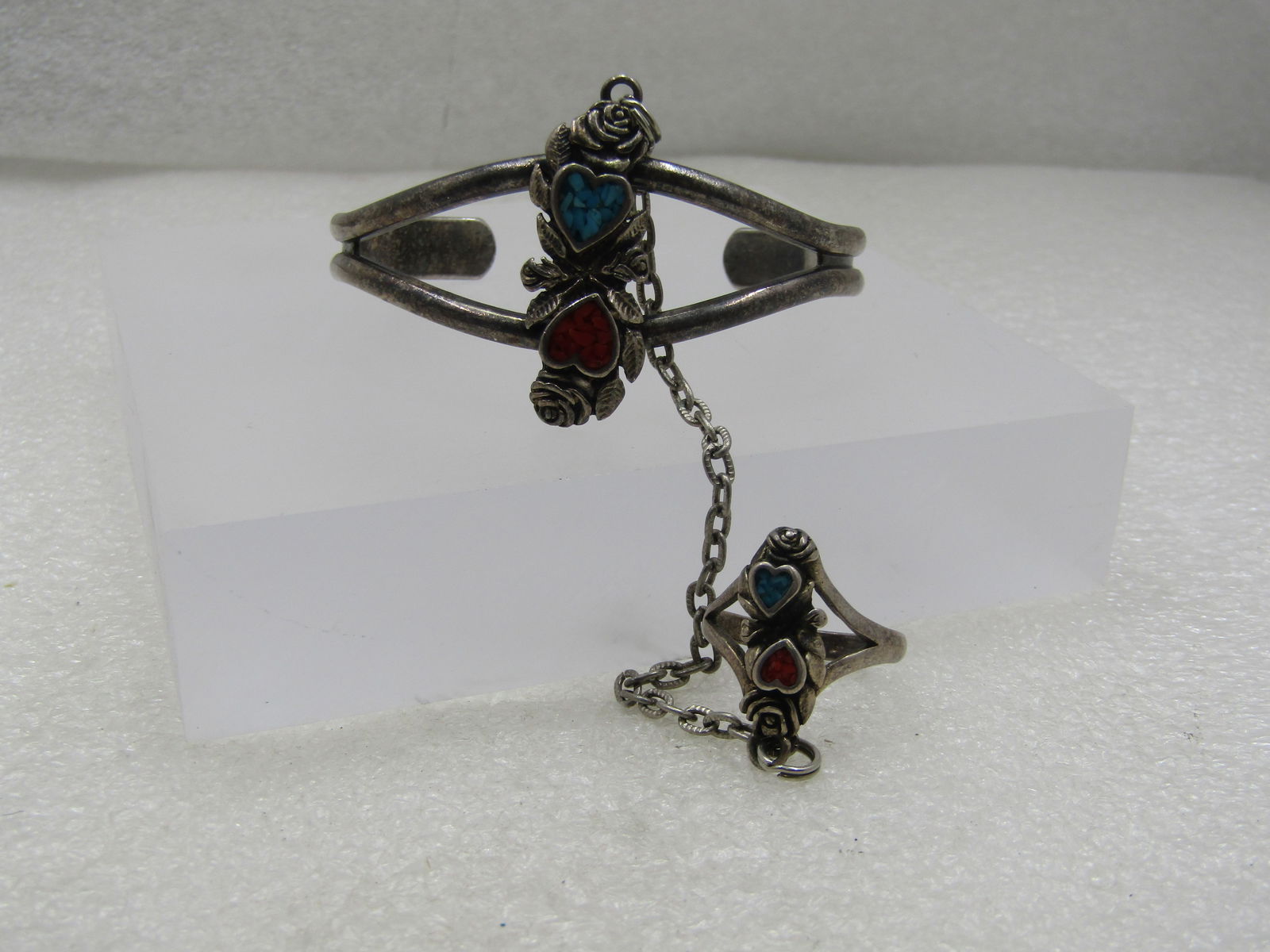 Vintage Southwestern Turquoise Coral Chip Cuff Bracelet & Attached Ring, 1988: Vintage Southwestern Turquoise Coral Chip Cuff Bracelet & Attached Ring, 1988. The cuff bracelet measures 6.75" including opening with a turquoise and coral chip heart and roses down the center