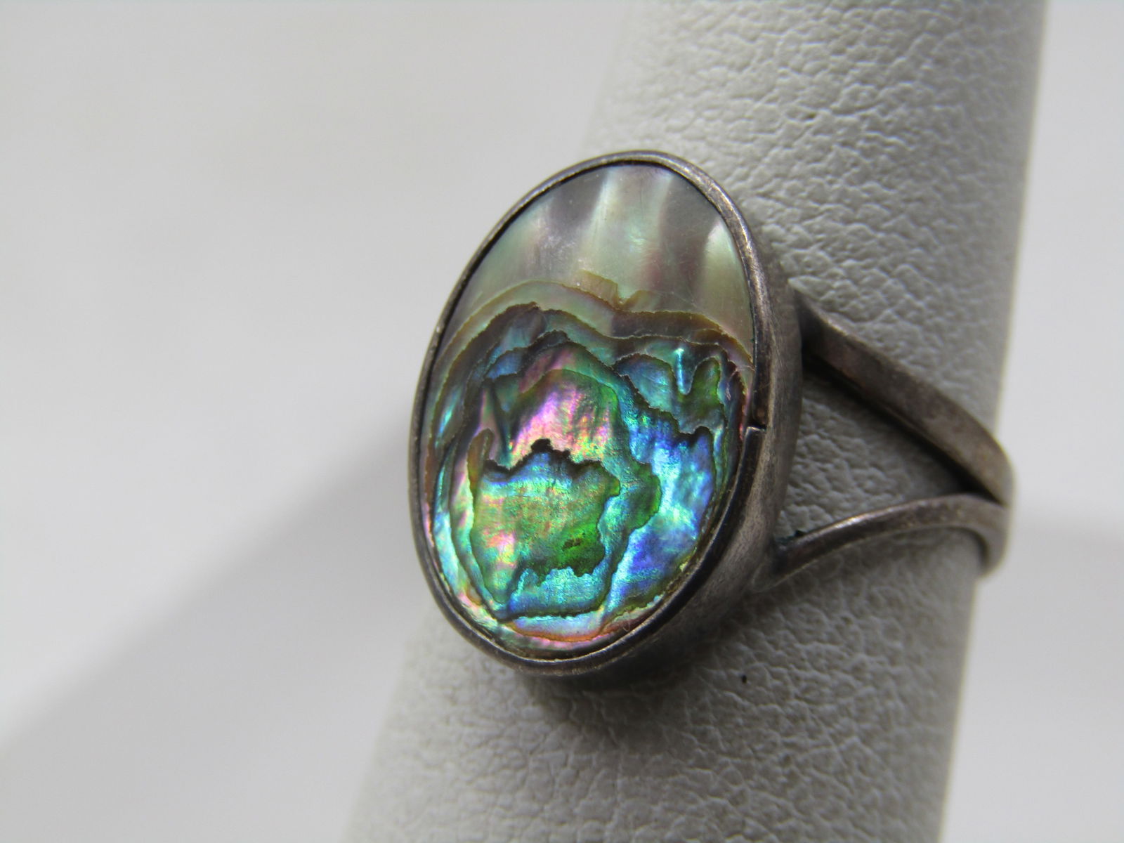 Vintage Sterling Abalone Ring, Sz. 5.5, Mexico, 1960's-1970's: Vintage Sterling Abalone Ring, Sz. 5.5, Mexico, 1960's-1970's. the abalone is set in a 15mm by 1mm oval bezel with a split V band that is appx. 8mm wide and forms into a single band around the lower