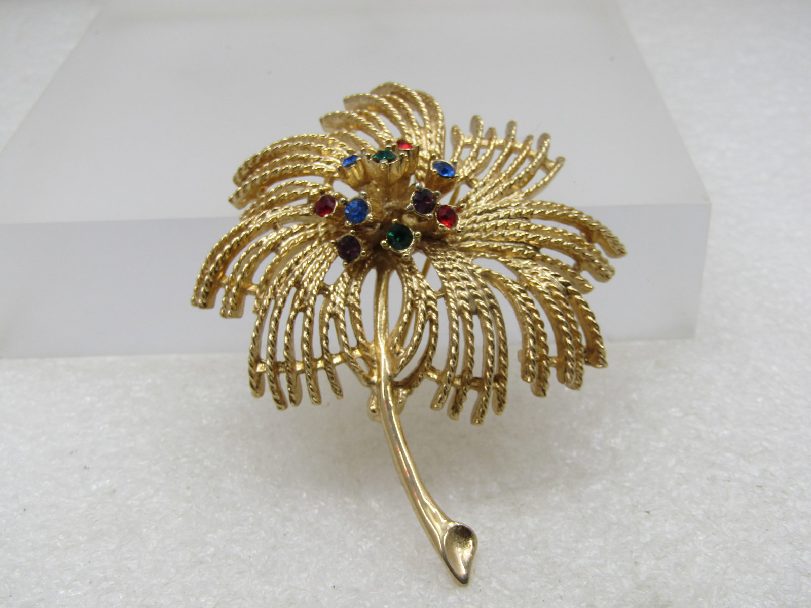 Vintage Rhinestone Firecracker Blossom Brooch, Sarah Coventry, 1960's-1970's: Vintage Rhinestone Fireworks Blossom Brooch, Sarah Coventry, 1960's-1970's. This has a rope strand type blossom with raised rhienstones cluster in the center - like a blossom but like a fireworks