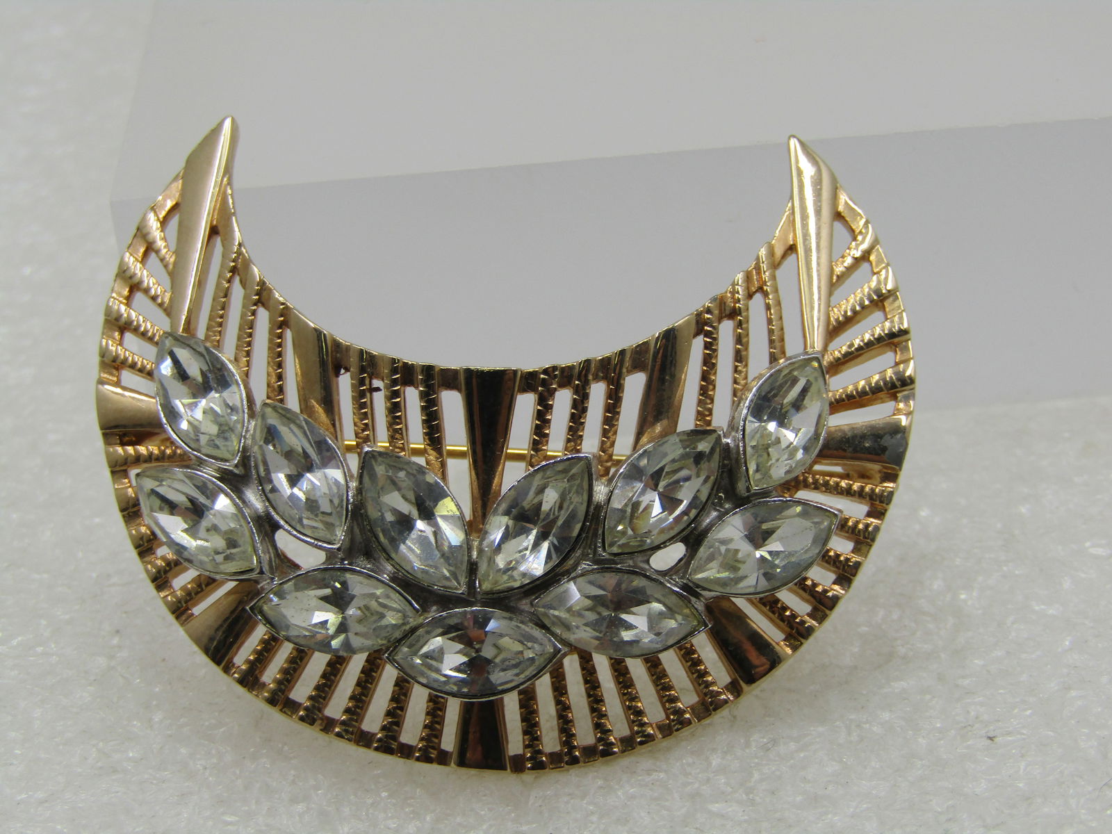 Vintage Clear Rhinestone Marquise Crescent Brooch, 1960's-1970's: . Vintage Clear Rhinestone Navette Crescent Brooch, 1960's-1970's. Gold tone textured and smooth brooch with eleven clear marquise silver tone bezel-set stones over the center. They are appx. 10mm