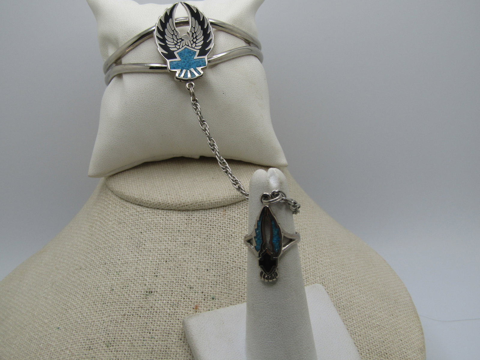 Vintage Enameled & Turquoise Chip Biker Bracelet with Attached Ring, 7" and Sz. 4.5: Enameled & Turquoise Chip Biker Bracelet with Attached Ring, 7" and Ring is Sz. 4.5. This is made with a silver tone metal with a split band on top fo the bracelet and a black enameled winged eagle