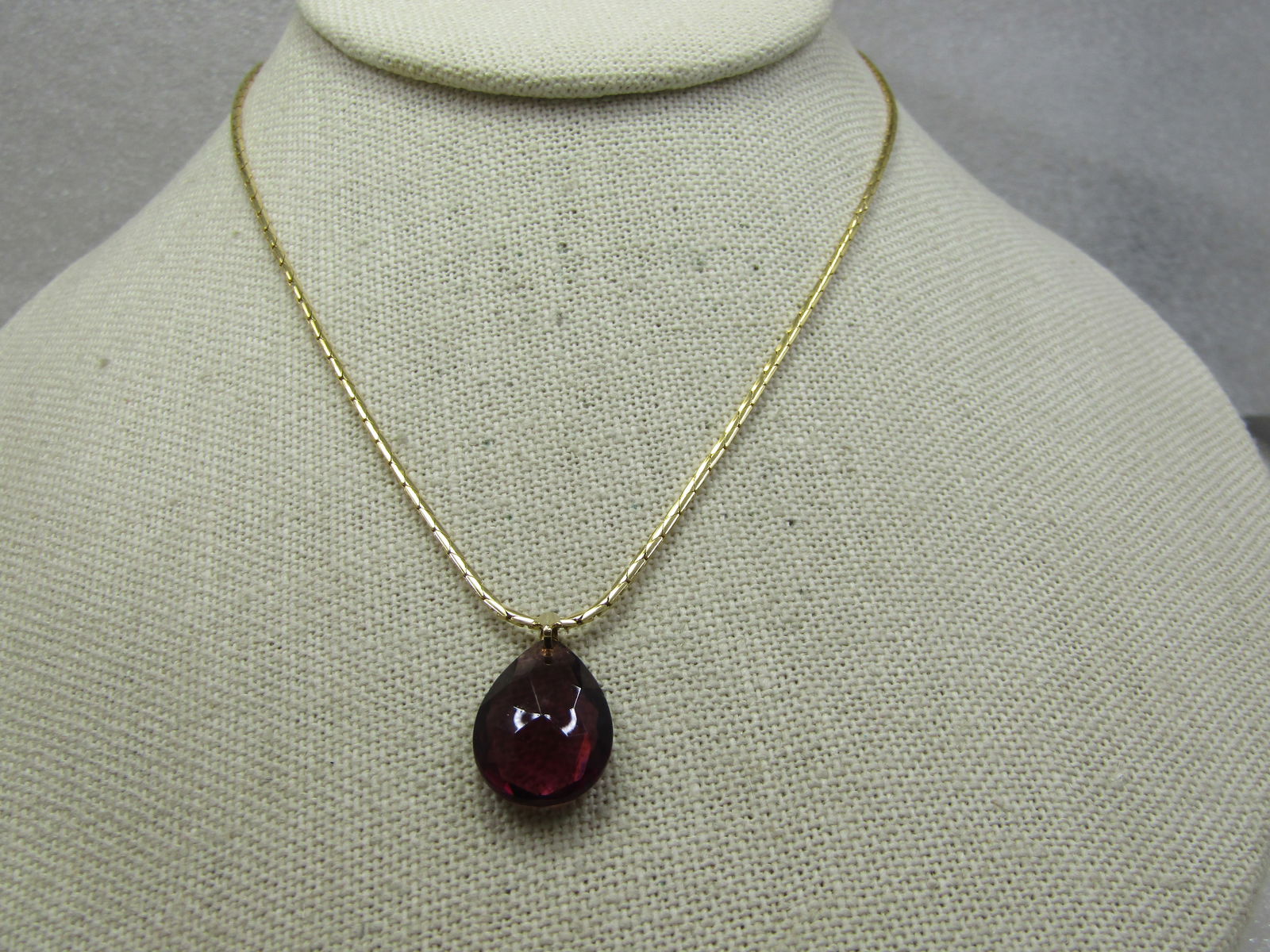 Vintage Purple Rhinestone Teardrop Necklace, 15": Vintage Purple Rhinestone Teardrop Necklace, 15". This has a single amethyst colored faceted teardrop pendant with a ridged tapered bail. The pendant is appx. 7/8" long and slightly over 1/2" wide. Th