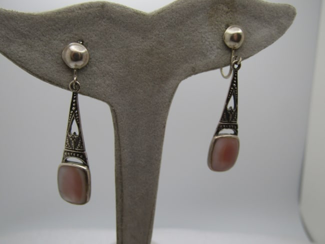 Vintage Sterling MOP Drop Clip Earrings, 1.75": DescriptionVintage Sterling MOP Drop Clip Earrings, 1.75". Cut-out heart in the drop with a stamped design. Bead like stud on the clip. It is marked sterling on the side of the clip and tests as sterl