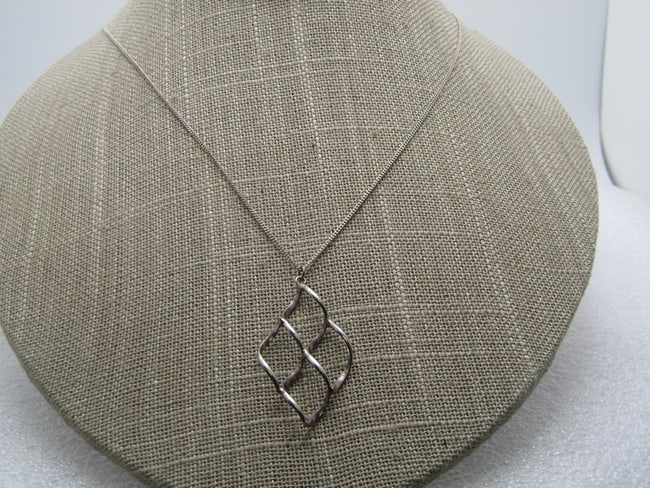 Vintage Sterling Open Diamond Shaped Necklace, 18", 1980's-1990's: Vintage Sterling Open Diamond Shaped Necklace, 18", 1980's-1990's. The pendant is a 3-D four section curved diamond shaped pendant with each section also being diamond shaped. The pendant is 1.5" long