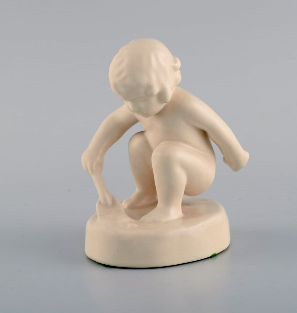 Adda Bonfils (1883-1943) for Ipsens Enke. Figure of girl with shovel in glazed ceramics. Model: Title: Adda Bonfils (1883-1943) for Ipsens Enke. Figure of girl with shovel in glazed ceramics. Model number 889. 1920s / 30's. Description: Adda Bonfils (1883-1943) for Ipsens Enke. Figure of girl