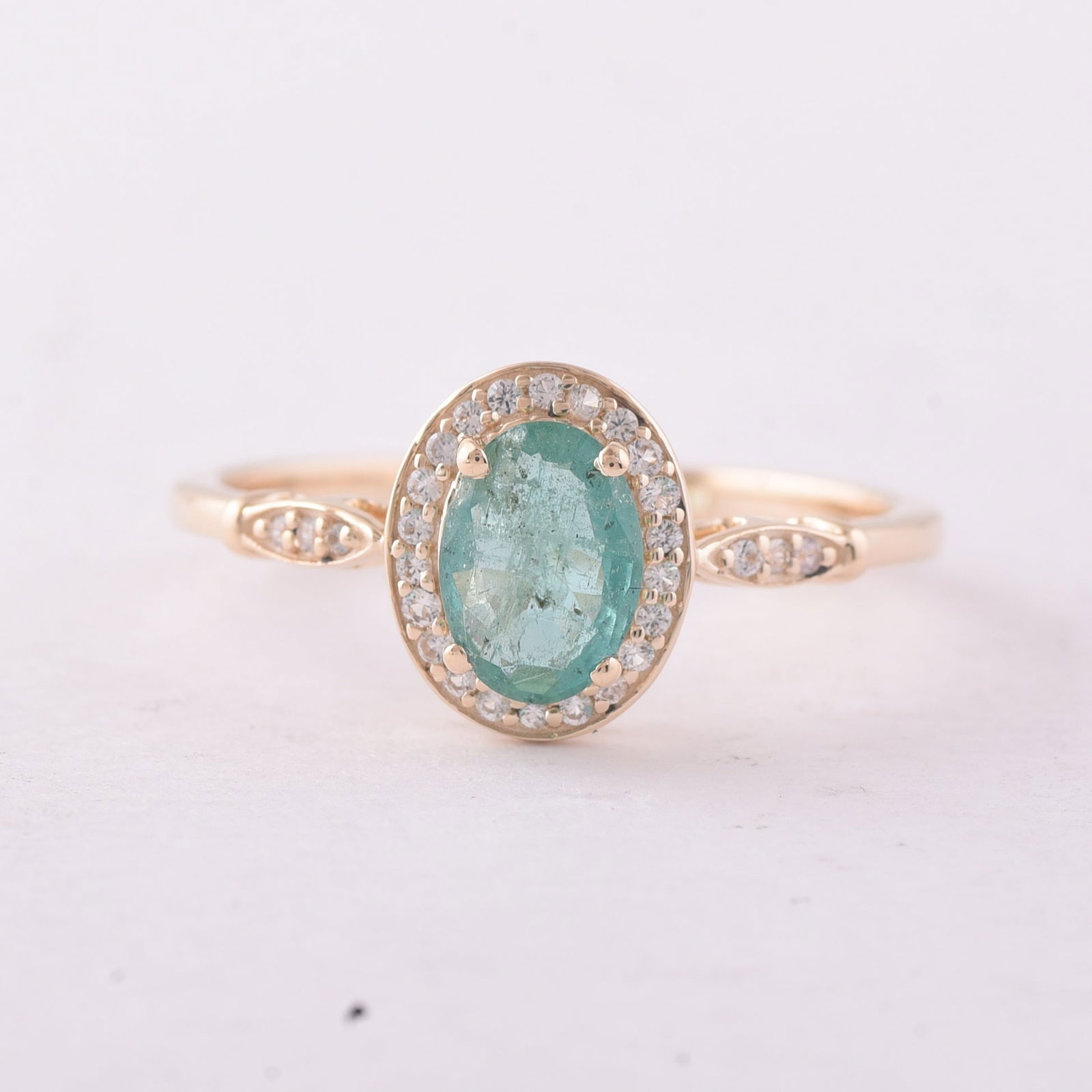 0.73 Ct Oval Emerald 9K Gold Ring: 0.73 Total Carat Emerald 9K Gold Ring Specifications - Total Weight 1.696 g - Center Gemstone Emerald - Gemstone Carat Weight 0.61 Carats - Gemstone Measurements 7X5 mm - Additional Gemstones White Sa