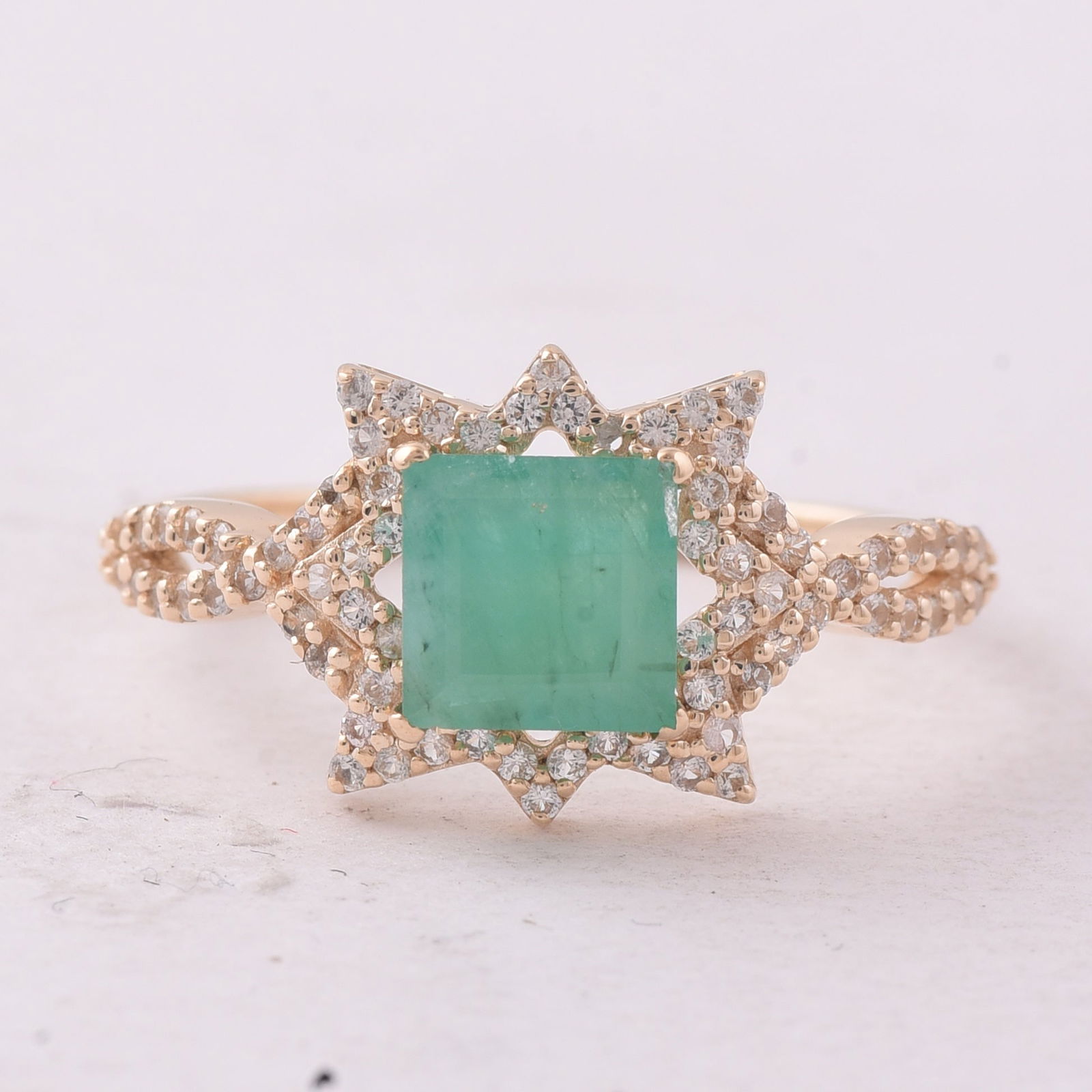1.15 Ct Square Emerald 9K Gold Ring: 1.15 Total Carat Emerald 9K Gold Ring Specifications - Total Weight 1.773 g - Center Gemstone Emerald - Gemstone Carat Weight 0.84 Carats - Gemstone Measurements 6X6 mm - Additional Gemstones White Sa