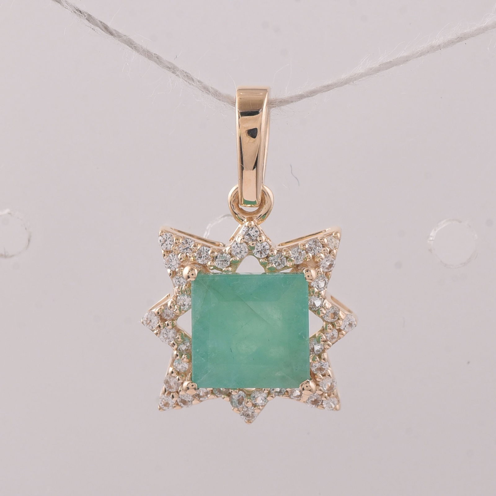1.16 Ct Square Emerald 9K Gold Pendant: 1.16 Total Carat Emerald 9K Gold Pendant Specifications - Total Weight 1.053 g - Center Gemstone Emerald - Gemstone Carat Weight 1 Carats - Gemstone Measurements 6X6 mm - Additional Gemstones White Sa