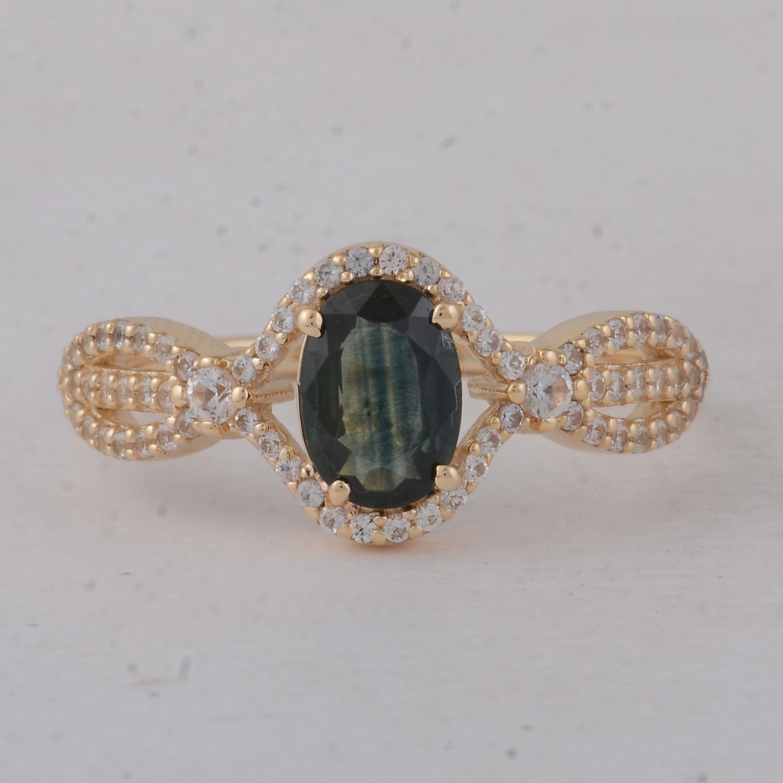 1.21 Ct Oval Blue Sapphire 9K Gold Ring: 1.21 Total Carat Blue Sapphire 9K Gold Ring Specifications - Total Weight 2.09 g - Center Gemstone Blue Sapphire - Gemstone Carat Weight 0.84 Carats - Gemstone Measurements 7.20X5X2.40 mm - Additional