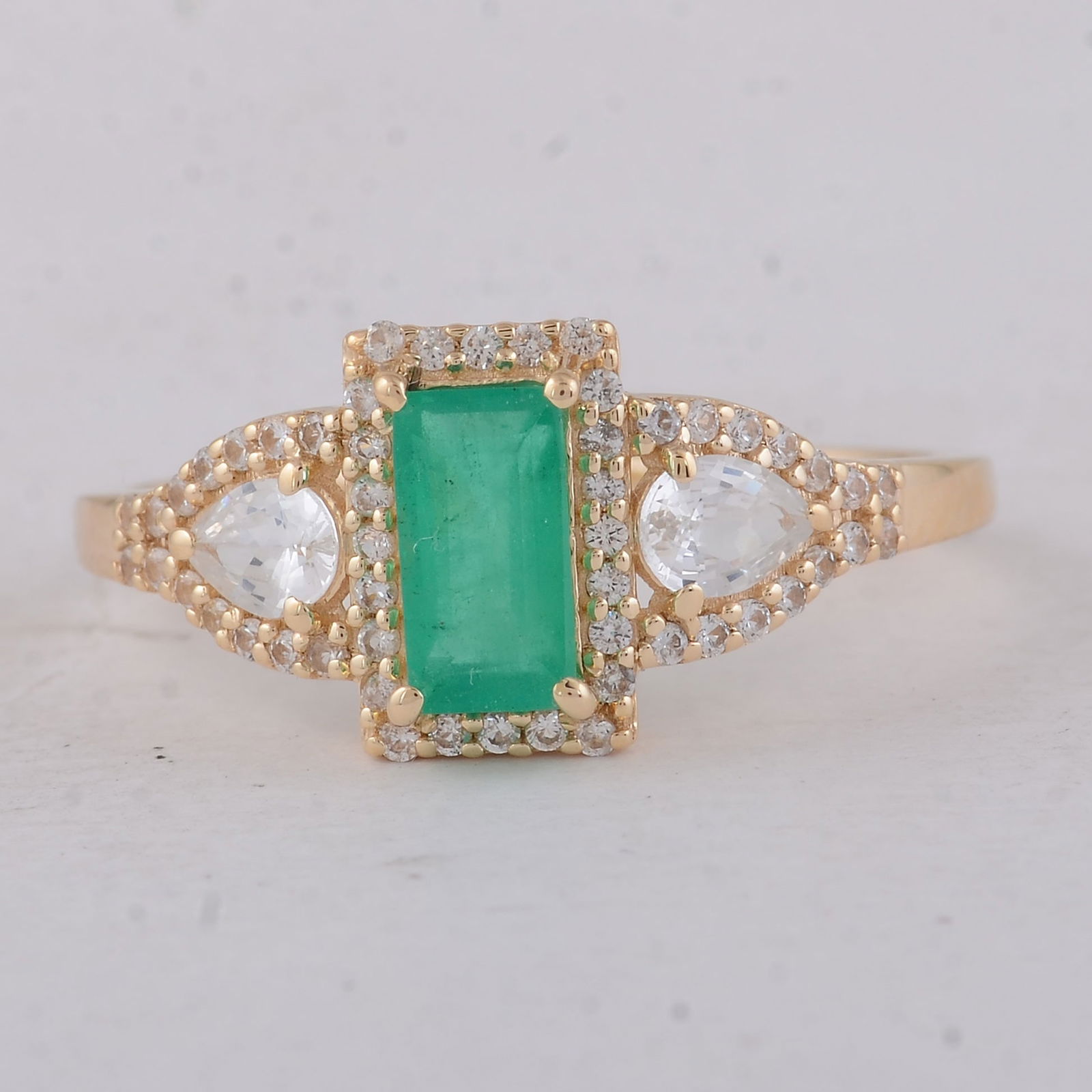 1.22 Ct Baguette Emerald 9K Gold Ring: 1.22 Total Carat Emerald 9K Gold Ring Specifications - Total Weight 1.82 g - Center Gemstone Emerald - Gemstone Carat Weight 0.68 Carats - Gemstone Measurements 6.80X3.70X3.20 mm - Additional Gemstone