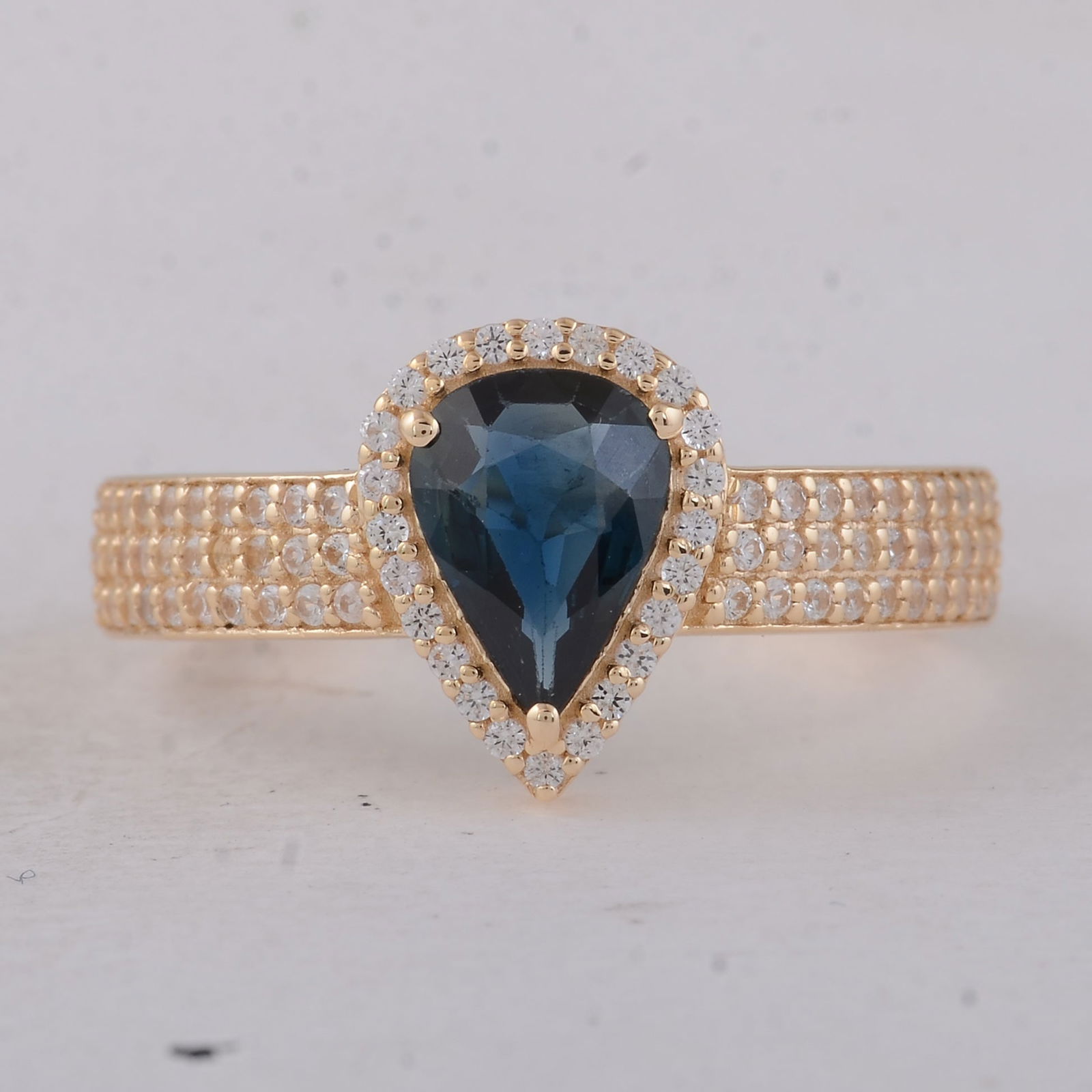 1.23 Ct Pear Sapphire 9K Gold Ring: 1.23 Total Carat Sapphire 9K Gold Ring Specifications - Total Weight 2.45 g - Center Gemstone Sapphire - Gemstone Carat Weight 0.88 Carats - Gemstone Measurements 8X5.80X2.60 mm - Additional Gemstones