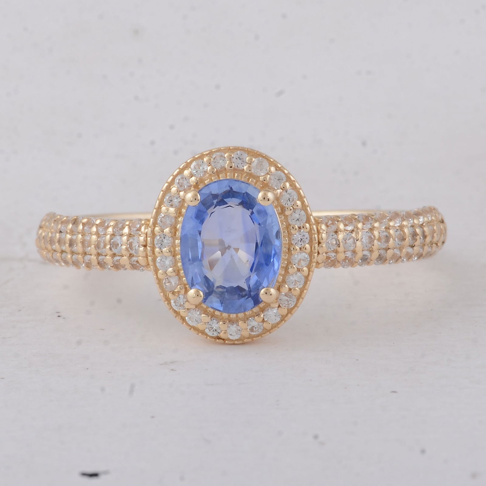 1.26 Ct Oval Sapphire 9K Gold Ring: 1.26 Total Carat Sapphire 9K Gold Ring Specifications - Total Weight 2.13 g - Center Gemstone Sapphire - Gemstone Carat Weight 0.89 Carats - Gemstone Measurements 6.90X5.20X2.70 mm - Additional Gemsto