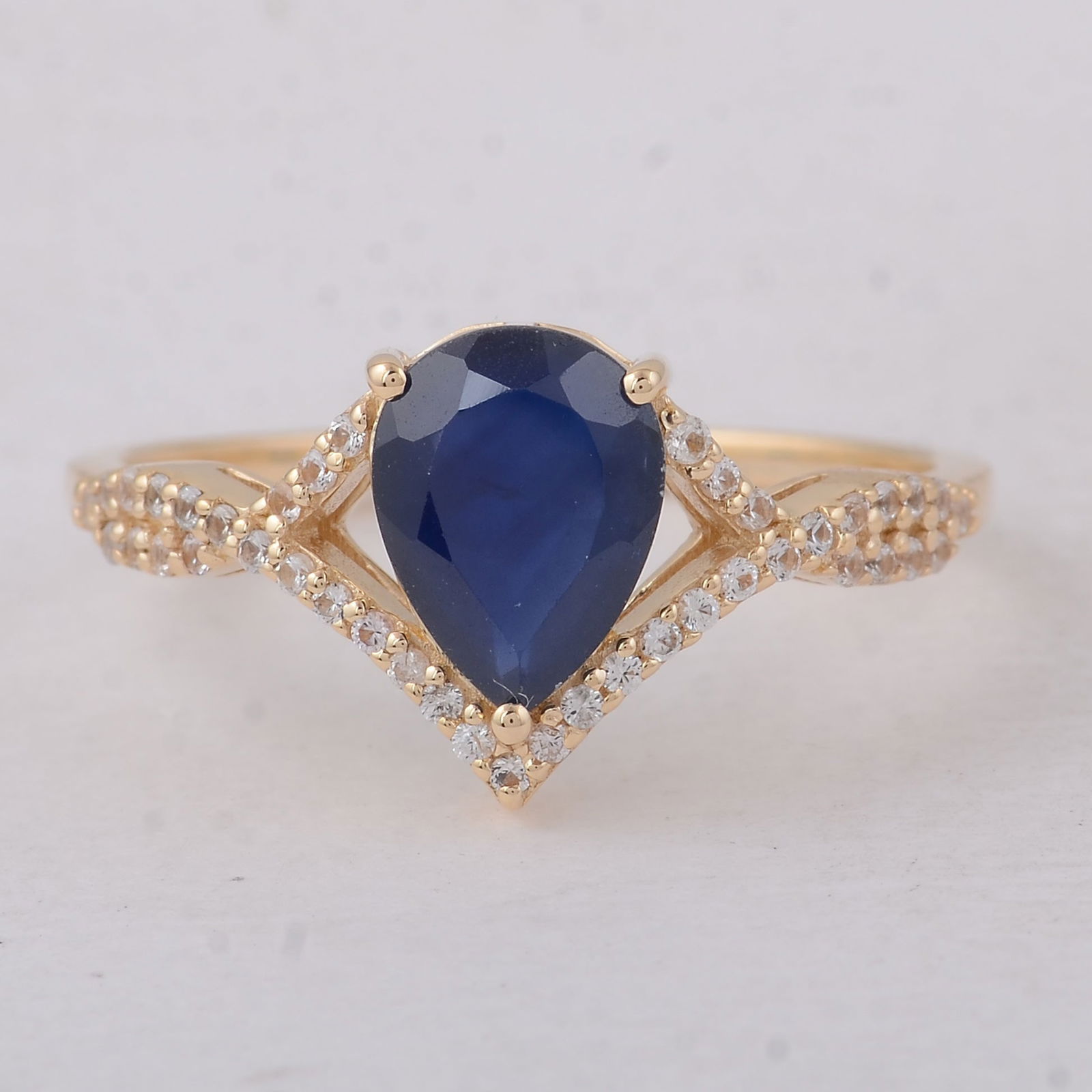 1.36 Ct Pear Sapphire 9K Gold Ring: 1.36 Total Carat Sapphire 9K Gold Ring Specifications - Total Weight 1.89 g - Center Gemstone Sapphire - Gemstone Carat Weight 1.2 Carats - Gemstone Measurements 8.20X6.20X2.80 mm - Additional Gemston