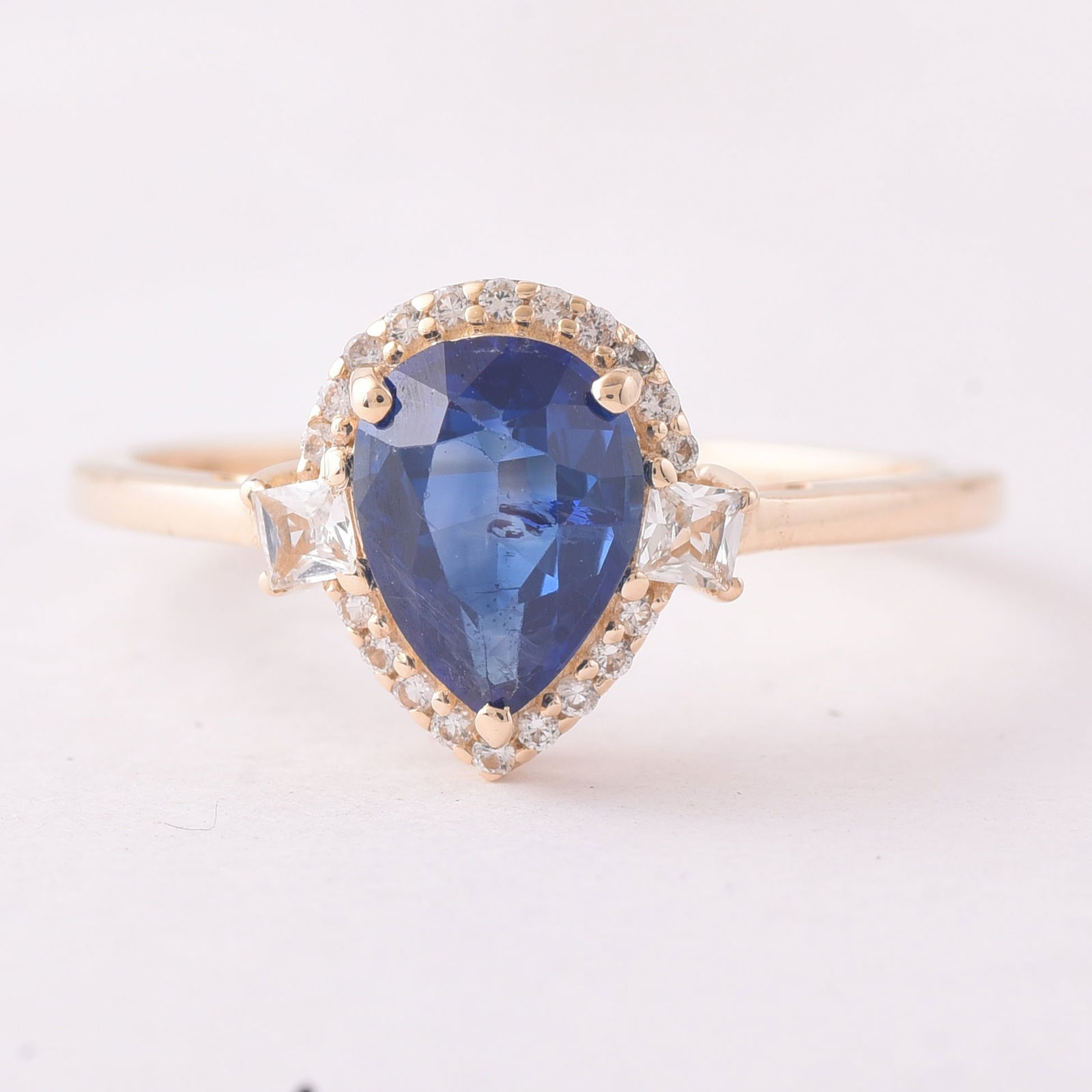 1.42 Ct Pear Sapphire 9K Gold Ring: 1.42 Total Carat Sapphire 9K Gold Ring Specifications - Total Weight 1.884 g - Center Gemstone Sapphire - Gemstone Carat Weight 1.28 Carats - Gemstone Measurements 8X6X3.60 mm - Additional Gemstones