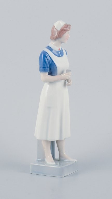 Royal Copenhagen, rare porcelain figurine of a nurse. - 2
