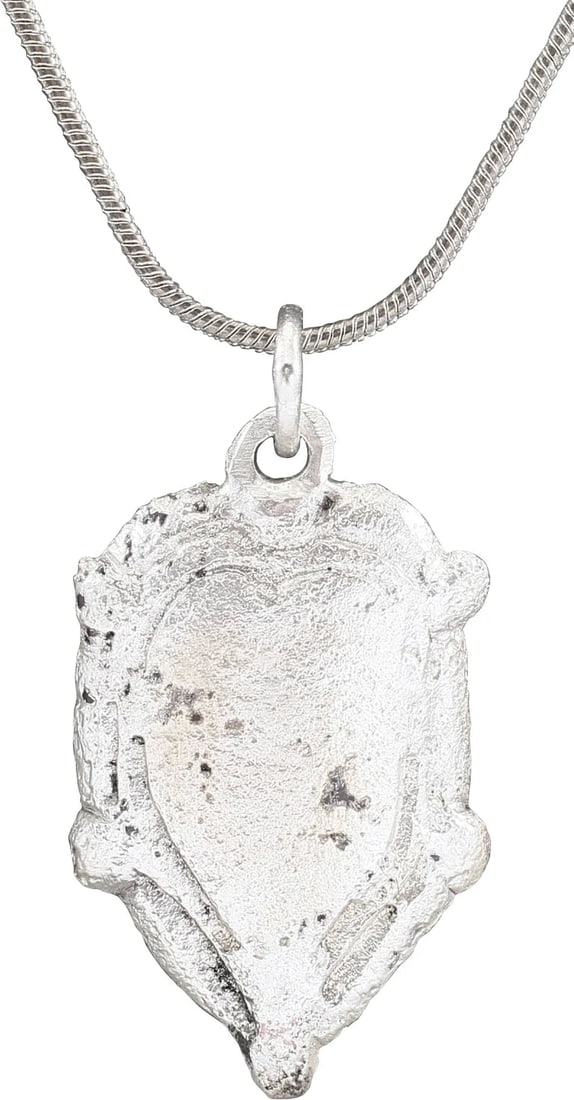 MEDIEVAL SCANDINAVIAN NECKLACE PENDANT: The period of conversion to Christianity for Vikings. A remnant of the old pagan mythology in the form of an anatomically accurate heart, with double raised border and nubs at the sixth point. A curio