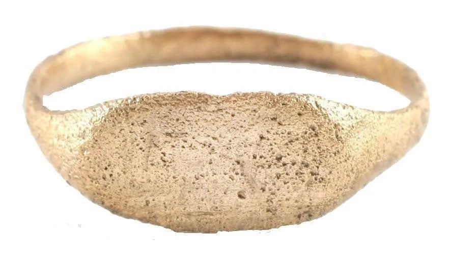 VIKING WARRIOR'S RING 9th-11th CENTURY AD, SZ 9 3/4: 9th-11th century AD. Size 9 3/4. 1.9mm band flared at the shoulders. The elongated oval bezel with runic ciphers. Surface textured from burial and restored in 24karat gold. See the reference image whi