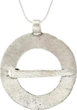 RARE VIKING PROTECTIVE BROOCH NECKLACE, 9th CENTURY AD: Silvered bronze, slightly under 2" diameter. Distinct broad form probably decorated originally. Slotted for its cross pin which is intact. Surface textured from burial. Professionally refurbished