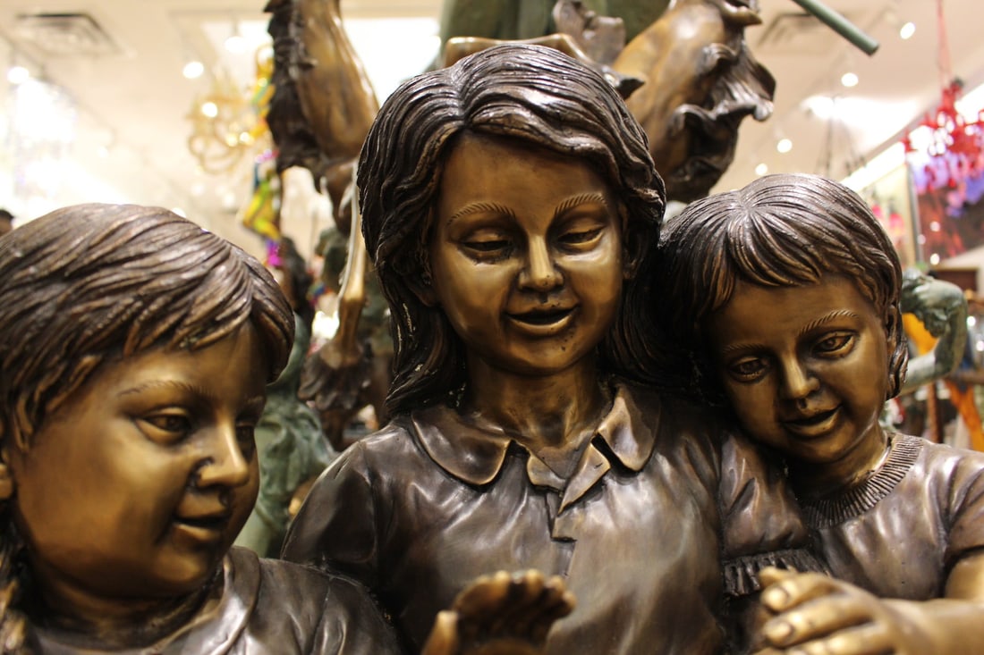 Three Children On Log Holding Bird Bronze Statue - Size: 55"L x 18"W x 38"H. - 10