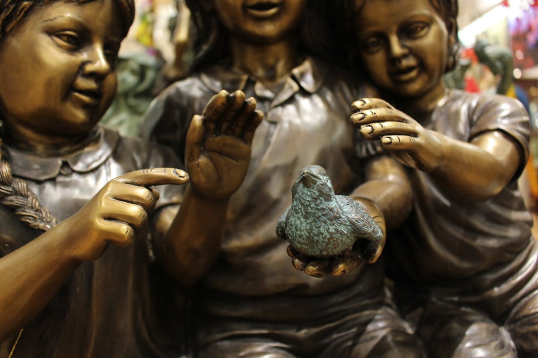 Three Children On Log Holding Bird Bronze Statue - Size: 55"L x 18"W x 38"H. - 11