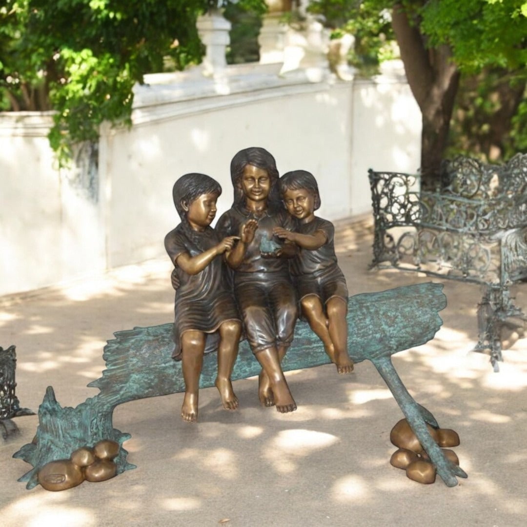 Three Children On Log Holding Bird Bronze Statue - Size: 55"L x 18"W x 38"H. - 2