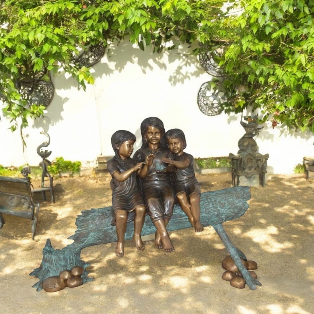 Three Children On Log Holding Bird Bronze Statue - Size: 55"L x 18"W x 38"H. - 4