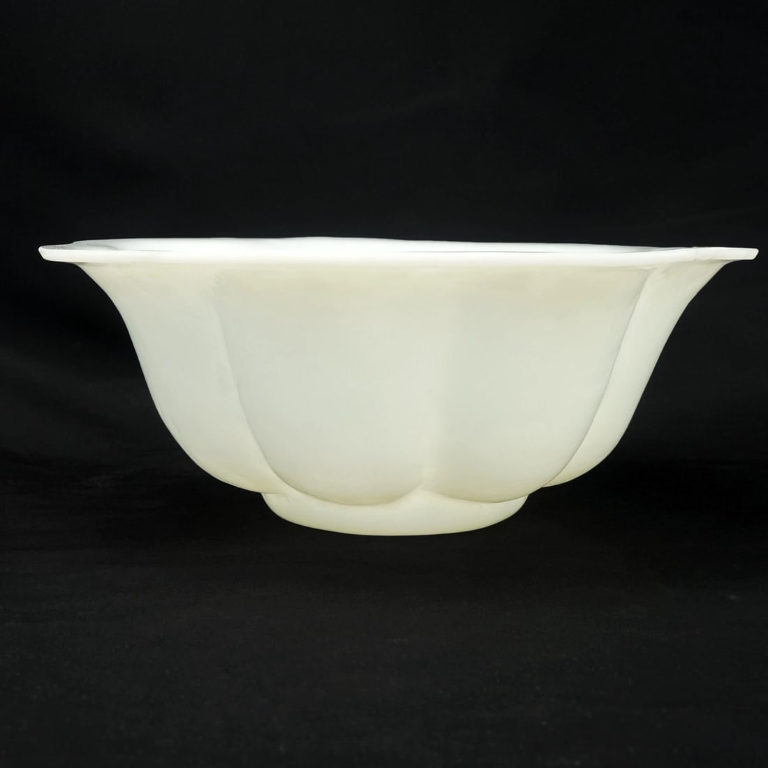 Chinese Peking Glass Fluted Bowl Republic Era: Title:Chinese Peking Glass Fluted Bowl Republic EraSize:8 5/8 in (21.9 cm) diameter x 3 ¼ in (8.3 cm) tall.Description:A large translucent very pale green Peking Glass bowl that when lit by a
