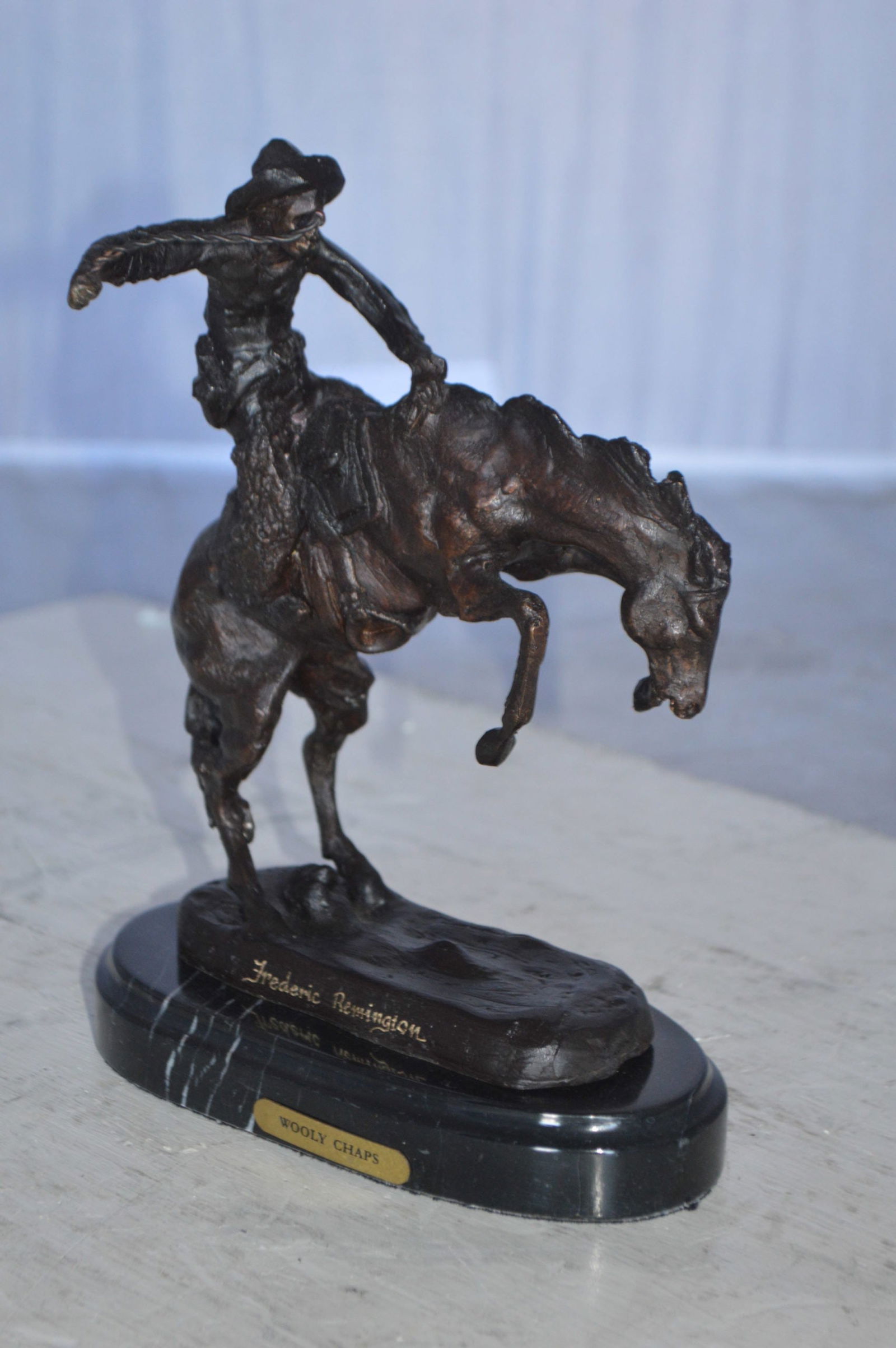 Wooly Chaps Bronze Statue by Remington 13H - Size: 8"L x 3"W x 9"H. - 13