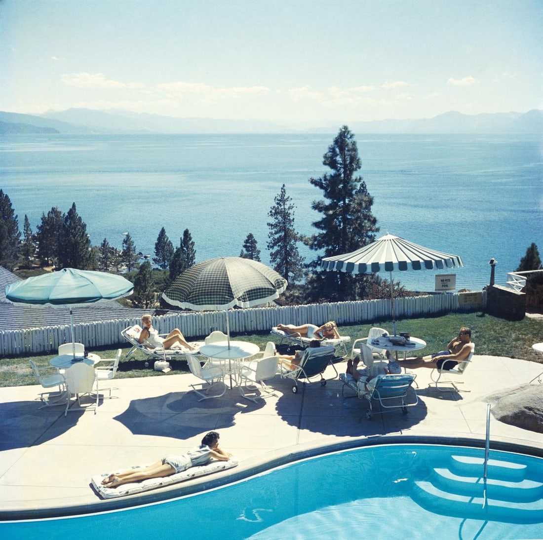 Slim Aarons 'Relaxing At Lake Tahoe' 1959 Official Limited Estate Edition: Title: Slim Aarons 'Relaxing At Lake Tahoe' 1959 Official Limited Estate Edition Description: Relaxing At Lake Tahoe' A group of people relaxing by a pool near Lake Tahoe, California, 1959. 40x40" inc