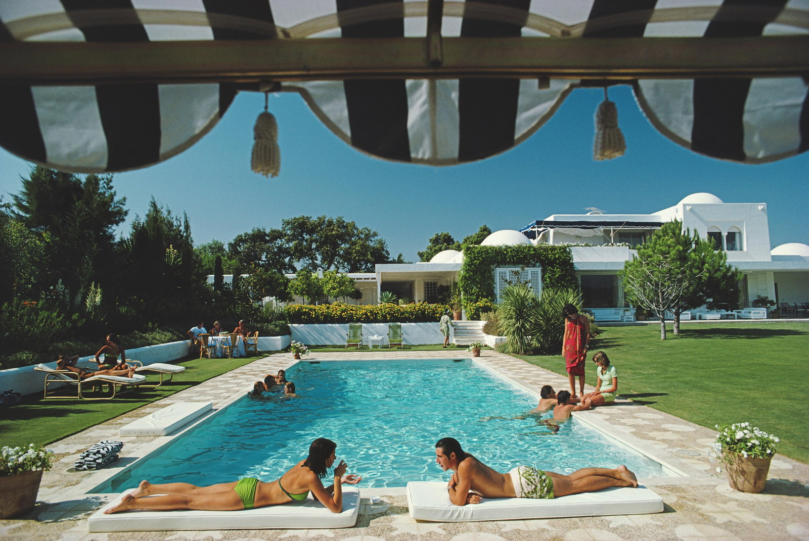 Slim Aarons 'Poolside In Sotogrande' 1975 Official Limited Estate Edition: 1975 (Printed Later): Title: Slim Aarons 'Poolside In Sotogrande' 1975 Official Limited Estate Edition: 1975 (Printed Later) Description: Poolside In Sotogrande' Bathers round a pool in Sotogrande, Spain, August 1975. 40