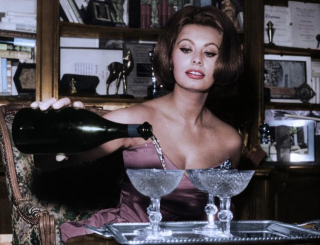 Sophia Loren Pouring Champagne in Glasses - Oversize Print: 1962 (Printed Later): Title: Sophia Loren Pouring Champagne in Glasses - Oversize Print: 1962 (Printed Later) Description: Sophia Loren Pouring Champagne in Glasses by Globe Photos A classic 1962 image featuring legendary