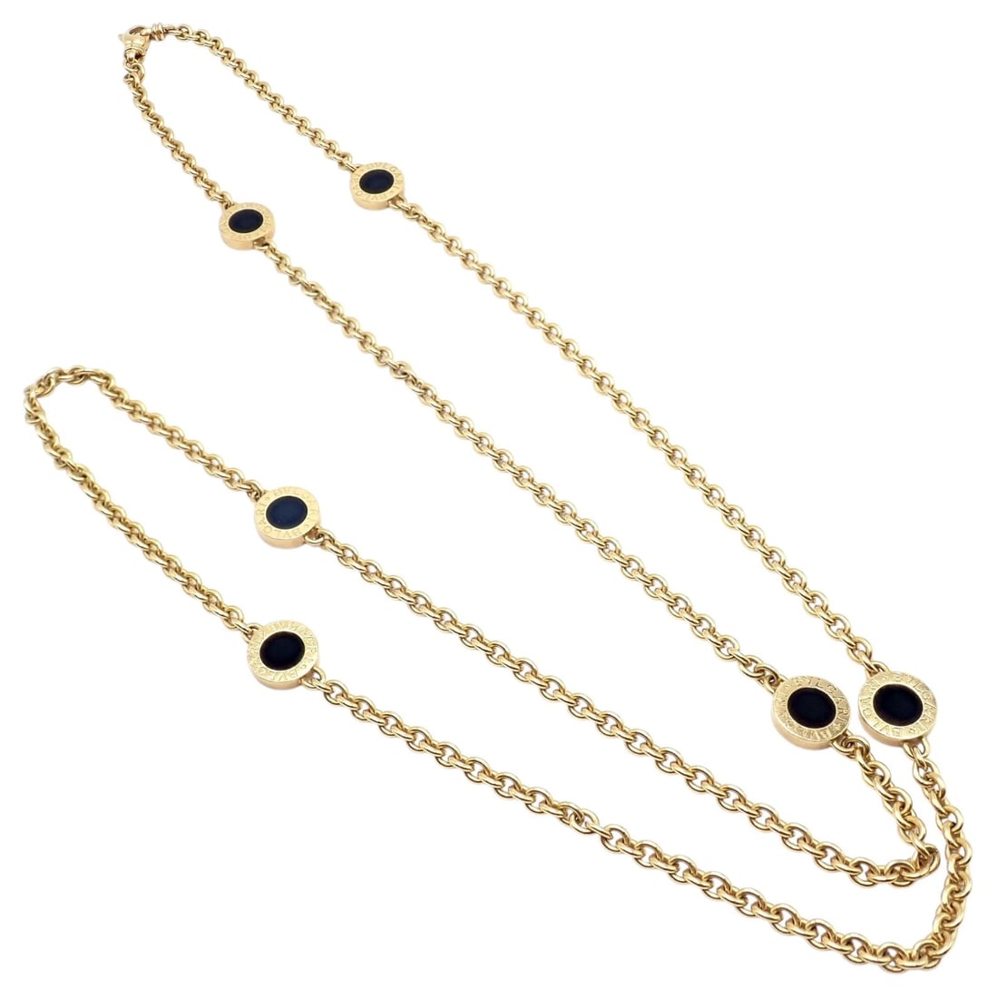 Authentic! Bvlgari Bulgari 18k Yellow Gold Onyx 29.5" Long Signature Necklace: Elegant Bvlgari Bulgari long necklace in luminous 18k yellow gold, featuring signature circular stations set with glossy black onyx. The 29.5-inch chain drapes fluidly, balancing refined minimalism wi