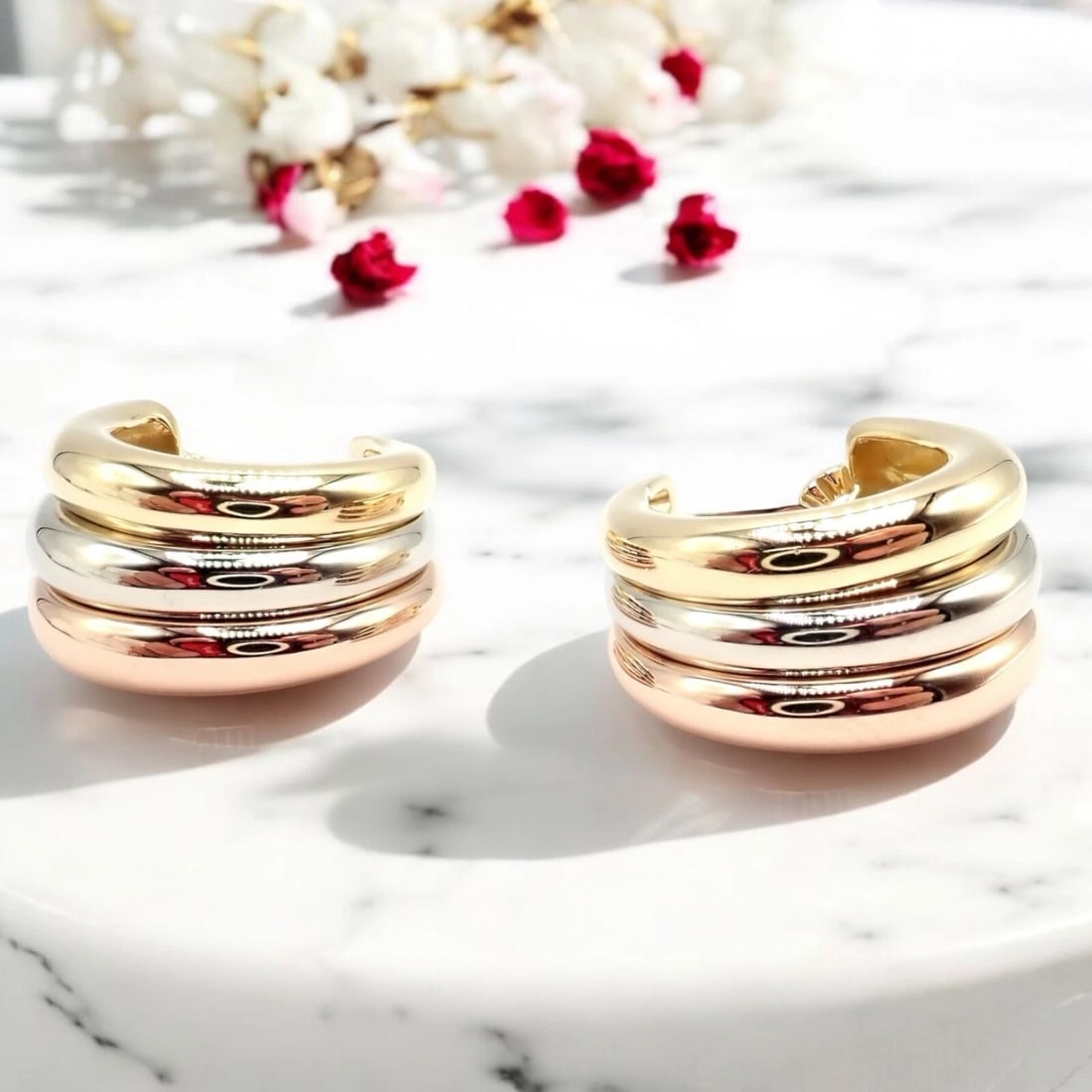 Authentic! Cartier 18k Tri-Color Gold Large Size Trinity Huggie Hoop Earrings: Authentic! Cartier 18k Tri-Color Gold Large Size Trinity Huggie Hoop Earrings About This Piece: These Cartier Trinity Huggie Hoop Earrings feature an iconic blend of 18k yellow, white, and rose gold.
