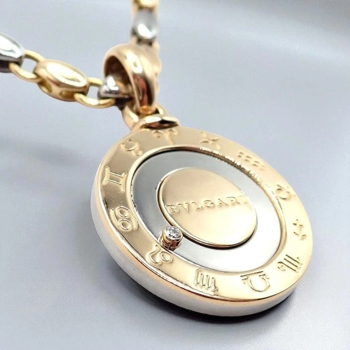 Authentic! Bulgari Bvlgari 18k Yellow Gold Steel Diamond Zodiac Pendant Necklace: Authentic! Bulgari Bvlgari 18k Yellow Gold Steel Diamond Zodiac Pendant Necklace About This Piece: Authentic Bulgari Bvlgari 18k yellow gold and steel diamond zodiac pendant necklace. Features a strik