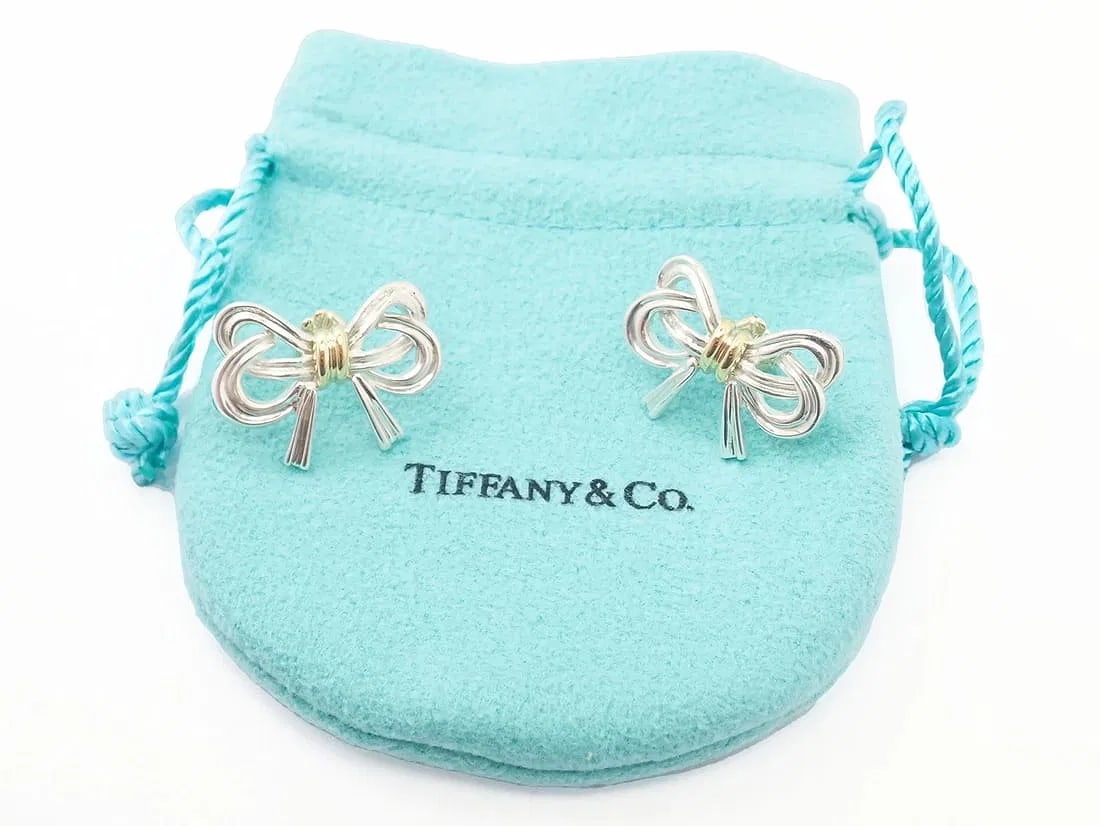 Authentic! Tiffany & Co 18k Yellow Gold & Sterling Silver Ribbon Bow Earrings: Authentic! Tiffany & Co 18k Yellow Gold & Sterling Silver Ribbon Bow Earrings About This Piece: Authentic Vintage Tiffany & Co 18k Yellow Gold and Sterling Silver Ribbon Bow Earrings with 18k Yellow G