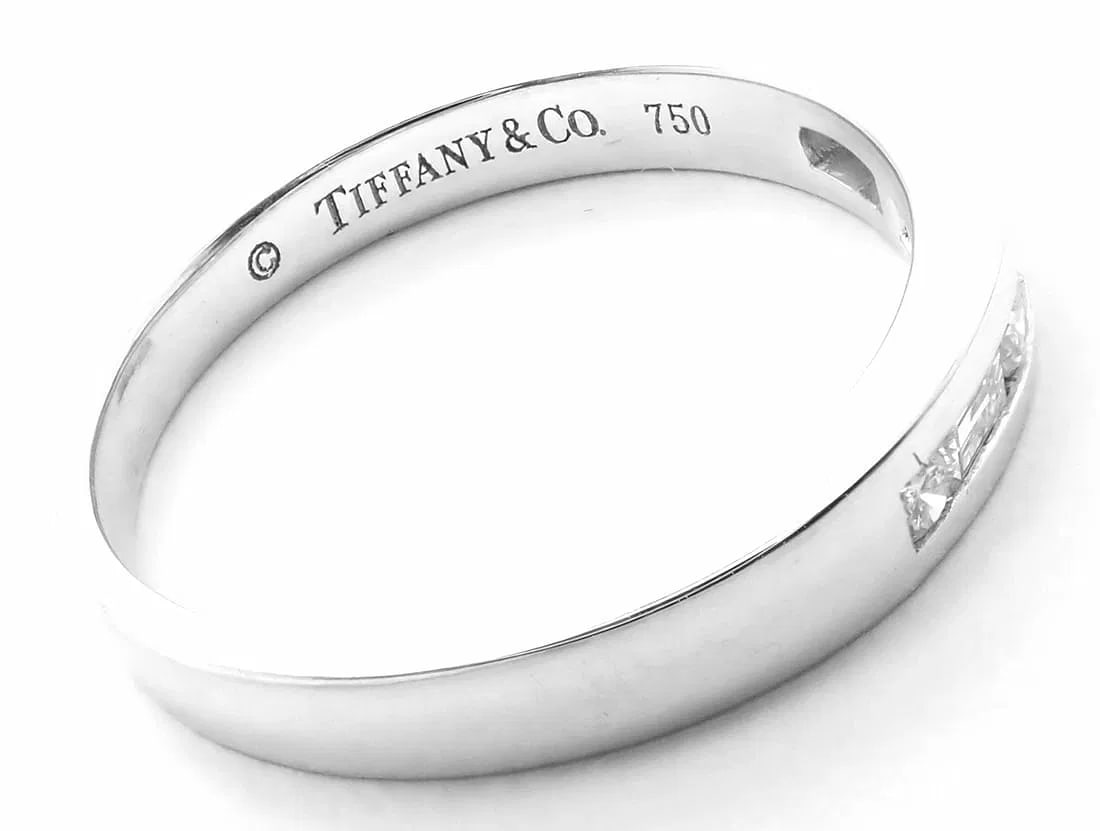 Authentic! Tiffany & Co 18k White Gold Diamond Channel Set Band Ring: Authentic! Tiffany & Co 18k White Gold Diamond Channel Set Band Ring About This Piece: Metal: 18 White Gold Ring Size: 6 1/5 Weight: Width: 3.1 grams 3mm Stones: 5 Round Brilliant Cut Diamond VS1 c
