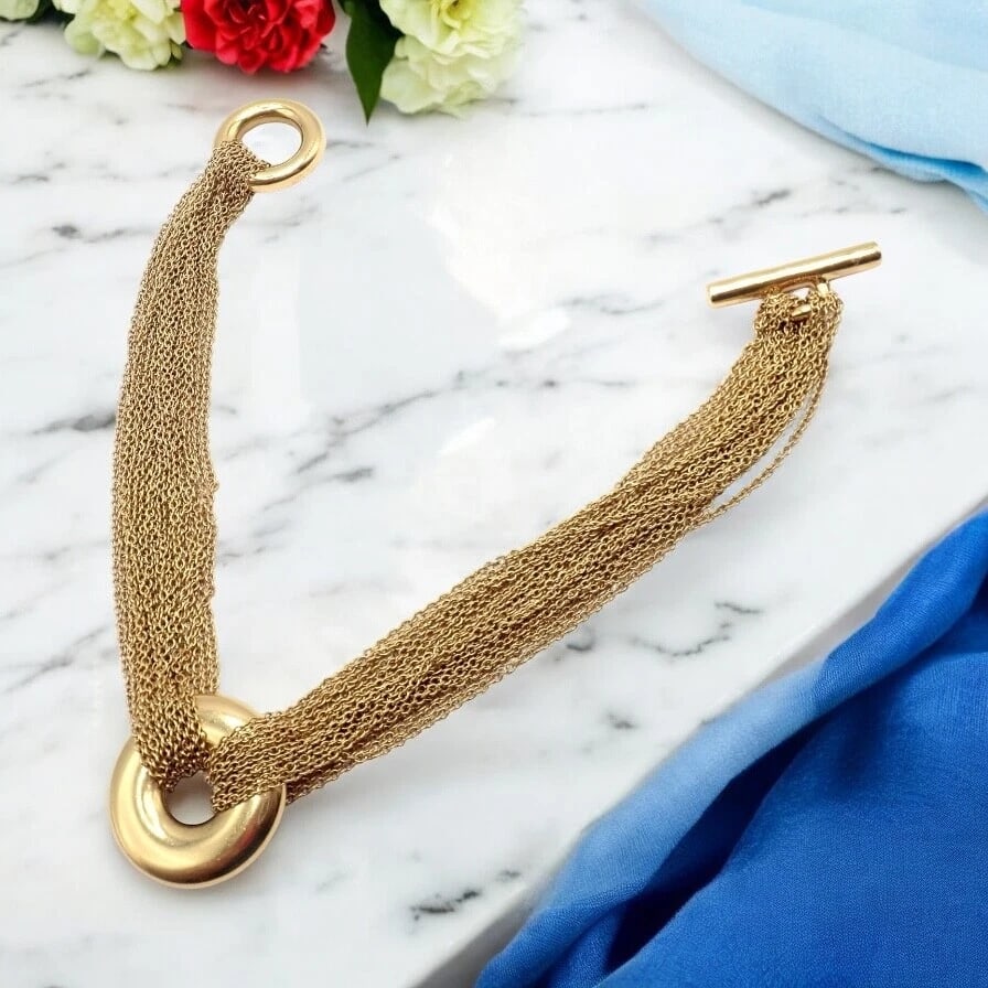 Authentic! Tiffany & Co 18k Yellow Gold Mesh Multi Strand Chain Toggle Bracelet: Authentic! Tiffany & Co 18k Yellow Gold Mesh Multi Strand Chain Toggle Bracelet About This Piece: Tiffany & Co's 18k Yellow Gold Mesh Multi-Strand Chain Toggle Bracelet radiates elegance. Its intricat