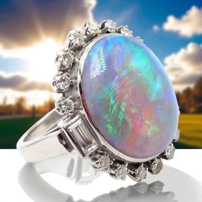 Antique Vintage Estate Palladium Diamond Opal Ring: Antique Vintage Estate Palladium Diamond Opal Ring About This Piece: This antique vintage estate ring features a mesmerizing larege opal cabochon with fiery rainbow play-of-color, set in lustrous pall
