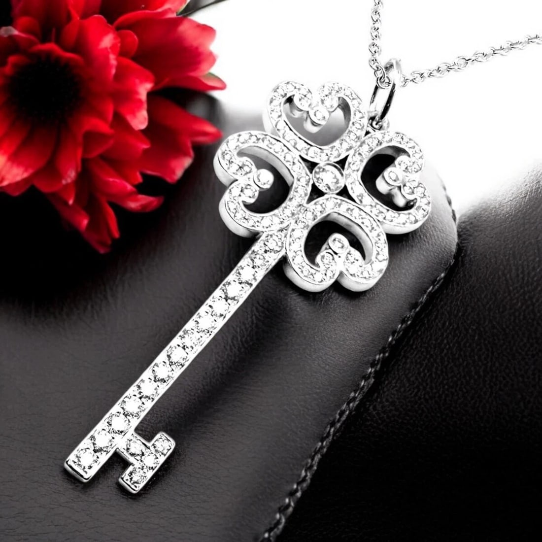 Tiffany & Co Platinum & 18k White Gold Enchant Quatra Heart Key Pendant Necklace: Tiffany & Co Platinum & 18k White Gold Enchant Quatra Heart Key Pendant Necklace About This Piece: The Tiffany & Co. Platinum & 18k White Gold Enchant Quatre Heart Key Pendant Necklace exudes elegance
