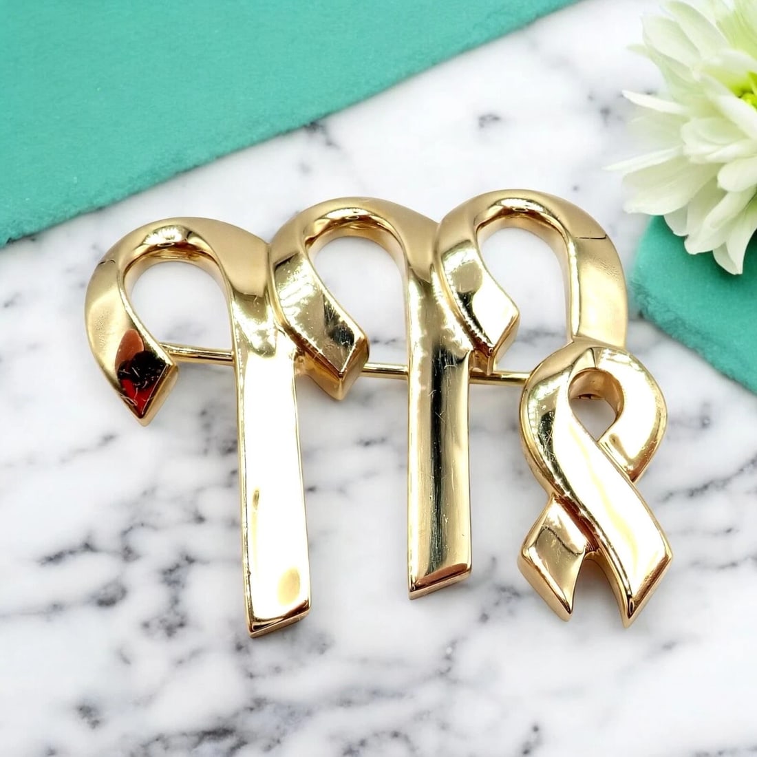 Authentic! Tiffany & Co Paloma Picasso 18k Yellow Gold Zodiac Virgo Pin Brooch: Designed by Paloma Picasso for Tiffany & Co, this 18k yellow gold Virgo pin brooch exudes astrological allure and signature artistry. A stylized Virgo symbol is delicately rendered in gleaming gold, r