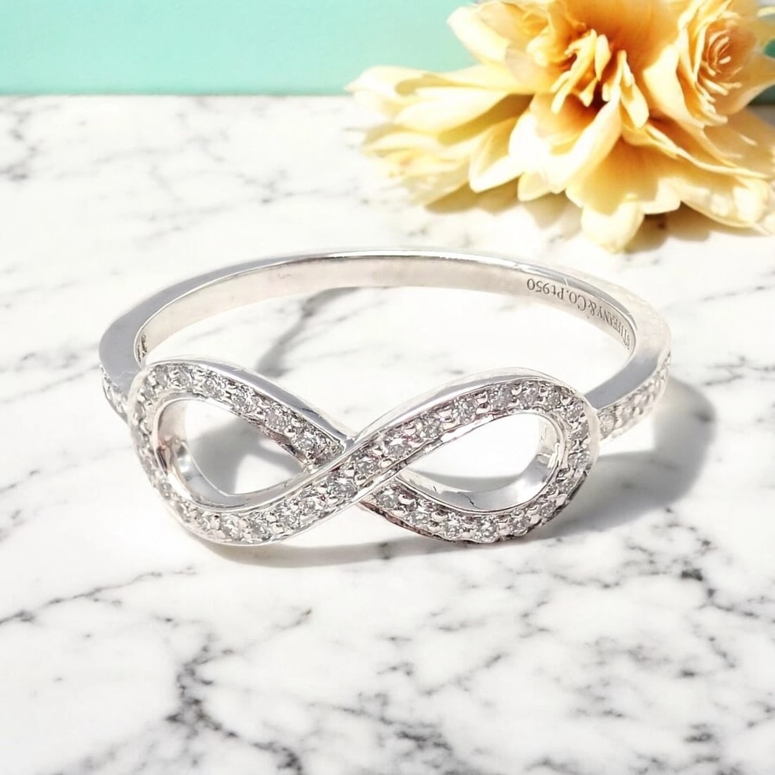 Tiffany & Co Platinum 0.12ct Diamond Infinity Stacking Ring sz 6.5: Symbolizing everlasting love, this Tiffany & Co Infinity ring is crafted in fine platinum, featuring 0.12 carats of dazzling diamonds. Perfectly sized at 6.5 for elegant stacking or wearing alone. Rad