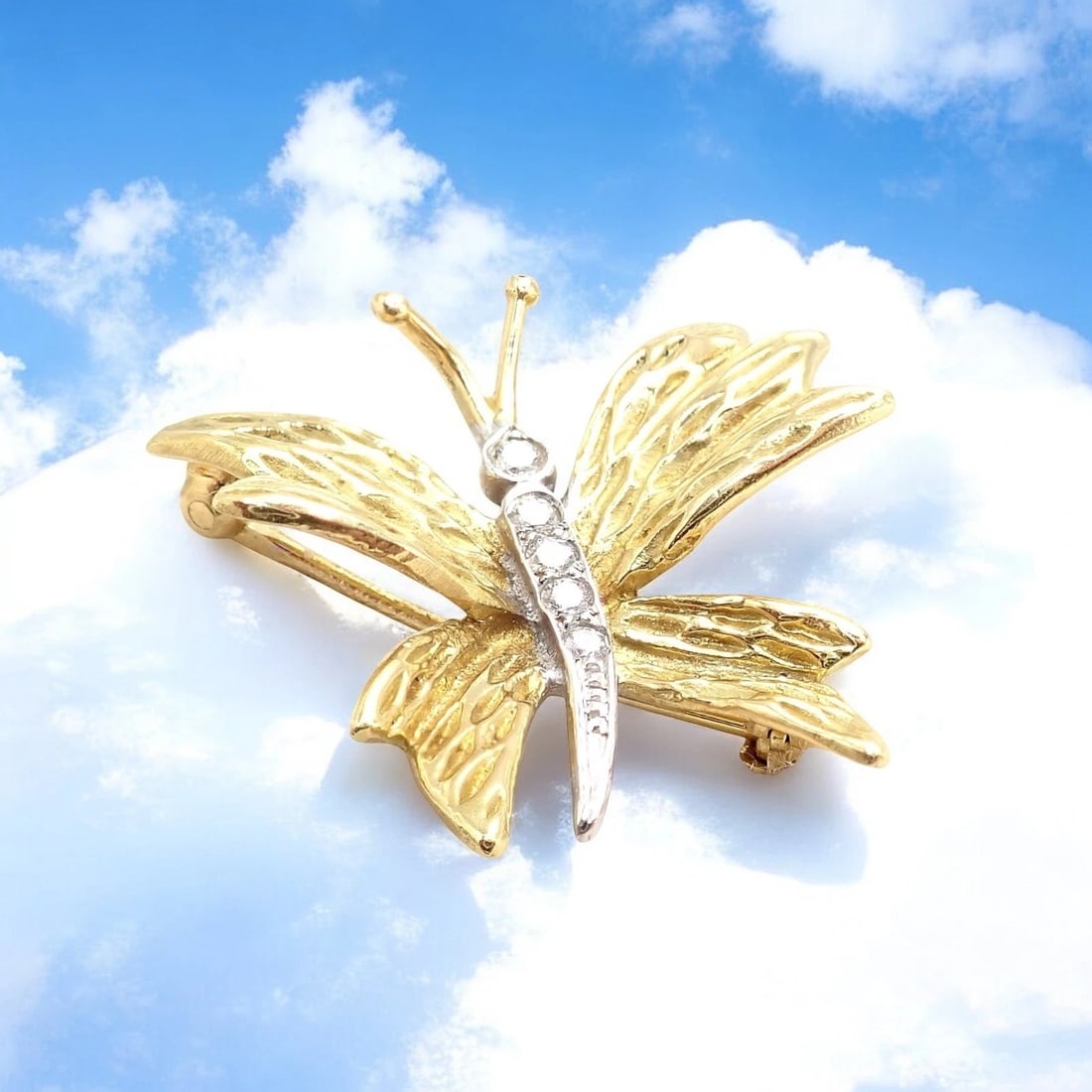 Authentic! Tiffany & Co 18k Yellow White Gold Butterfly Diamond Pin Brooch: This exquisite Tiffany & Co. butterfly brooch is crafted in luxurious 18k yellow and white gold. Featuring textured, lifelike wings, the piece is accented with sparkling diamonds set in platinum along