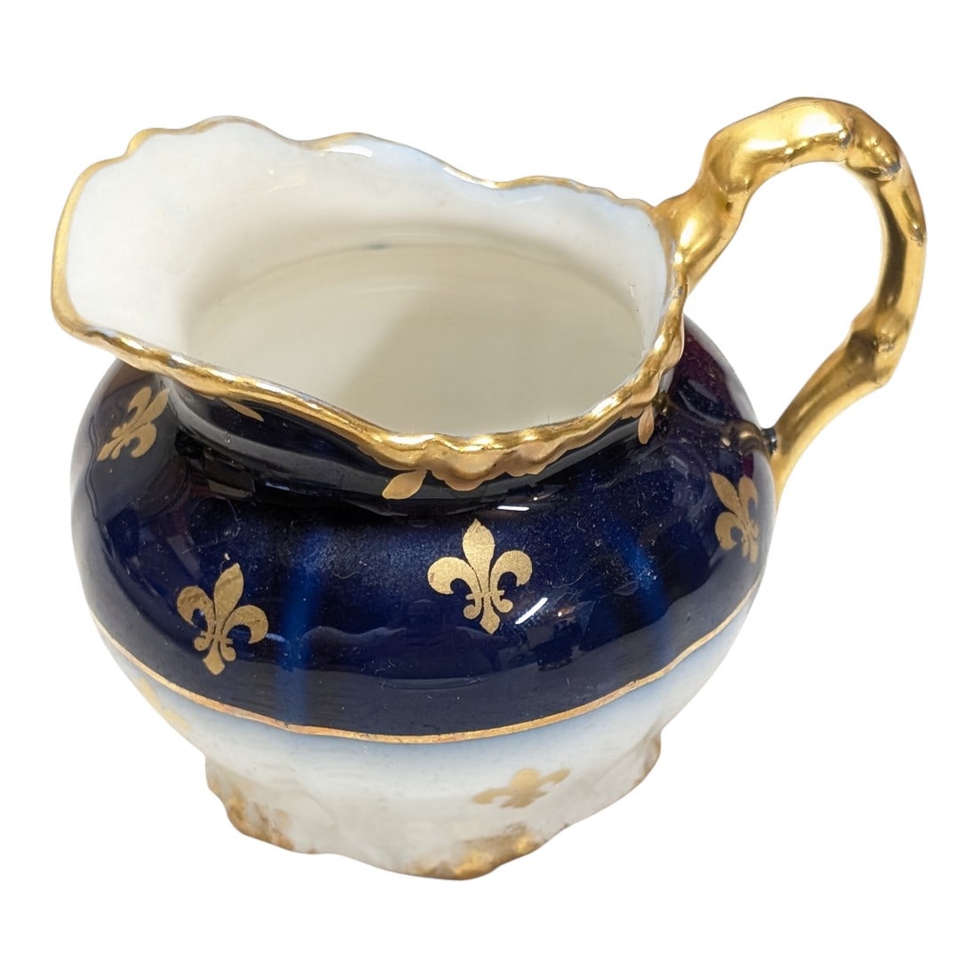 Late 19th Century J. Pouyat Limoges Porcelain Fleur De Lis Royal Blue & Gold Gilt Creamer: Royal velvet blue and thick gold gilt on soft paste porcelain creamer. Some of the hand painted Gilt is wearing off on the bottom (see photos) Marked J.P over L., indicating that the white porcelain p