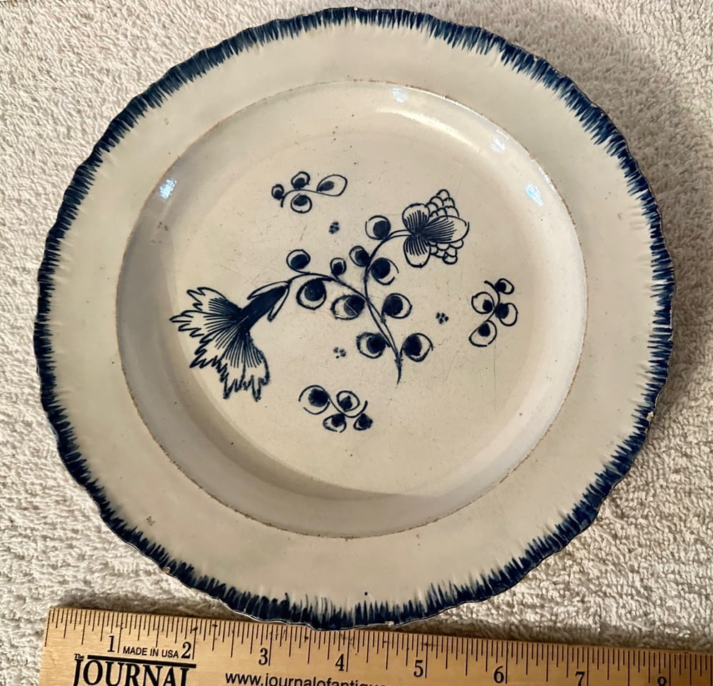 2 Shell Edge (Leeds) 8?? Plates Floral Centers: 2 early 19th century Shell Edge Plates, most probably by Leeds with floral centers, one with a green edge, the other with a blue edge. The blue edge plate (8 ¼” diameter) is slightly larger