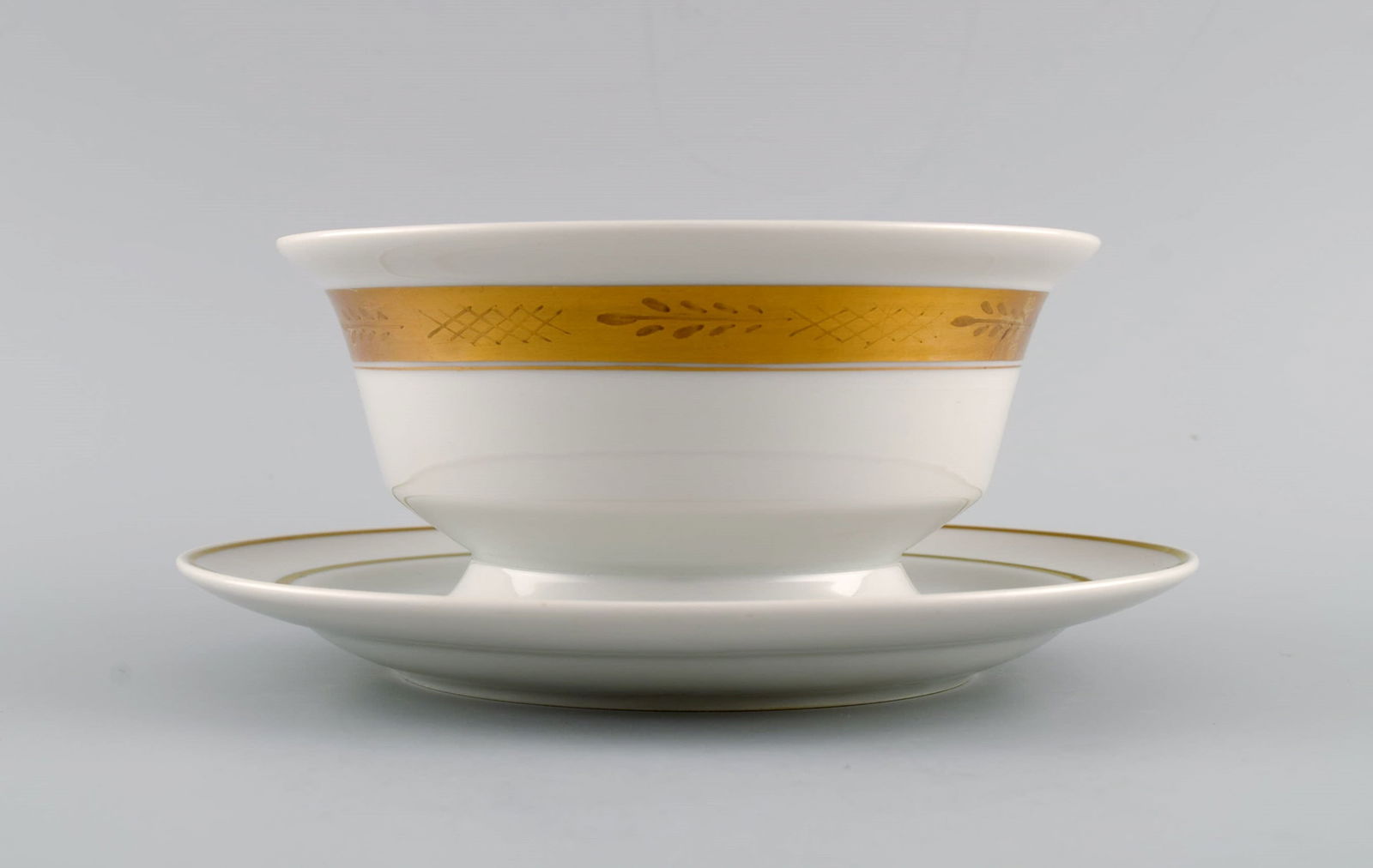 Royal Copenhagen service no. 607. Porcelain sauce bowl. Gold border with foliage. Model number - 2