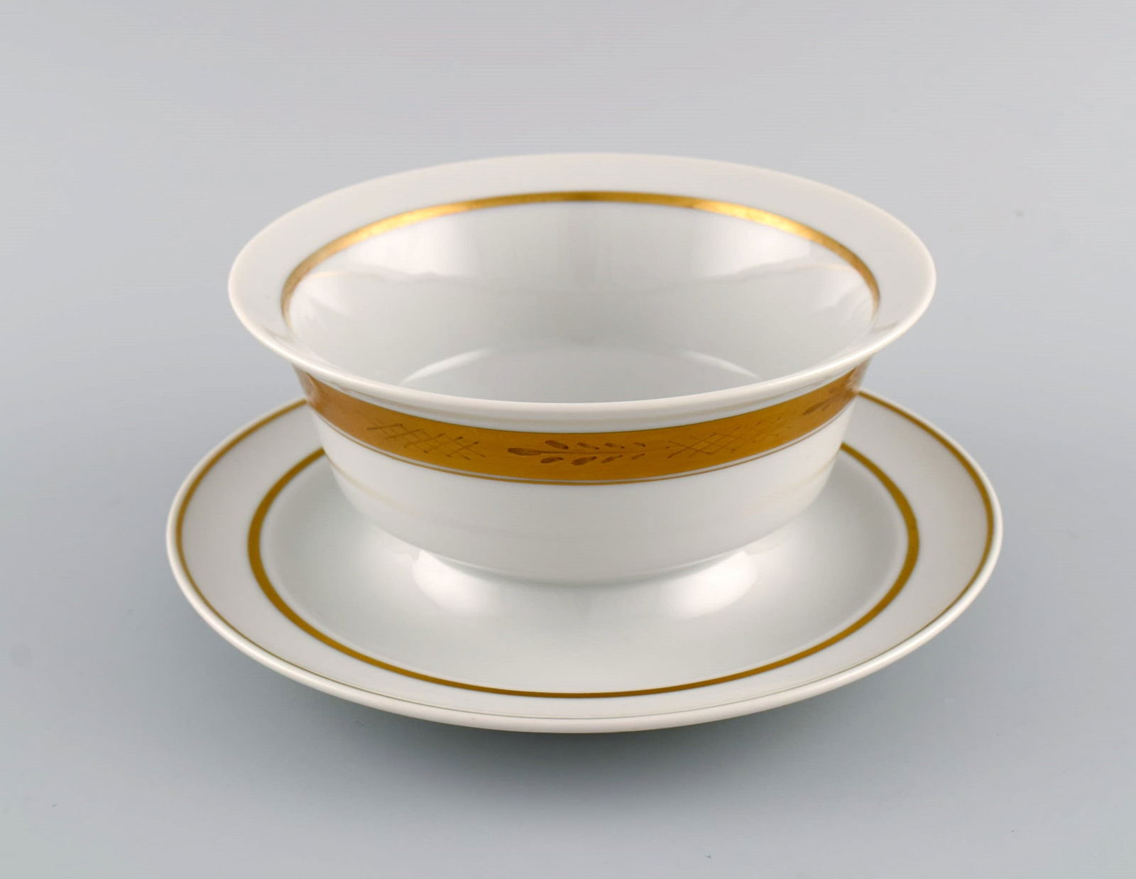 Royal Copenhagen service no. 607. Porcelain sauce bowl. Gold border with foliage. Model number - 3