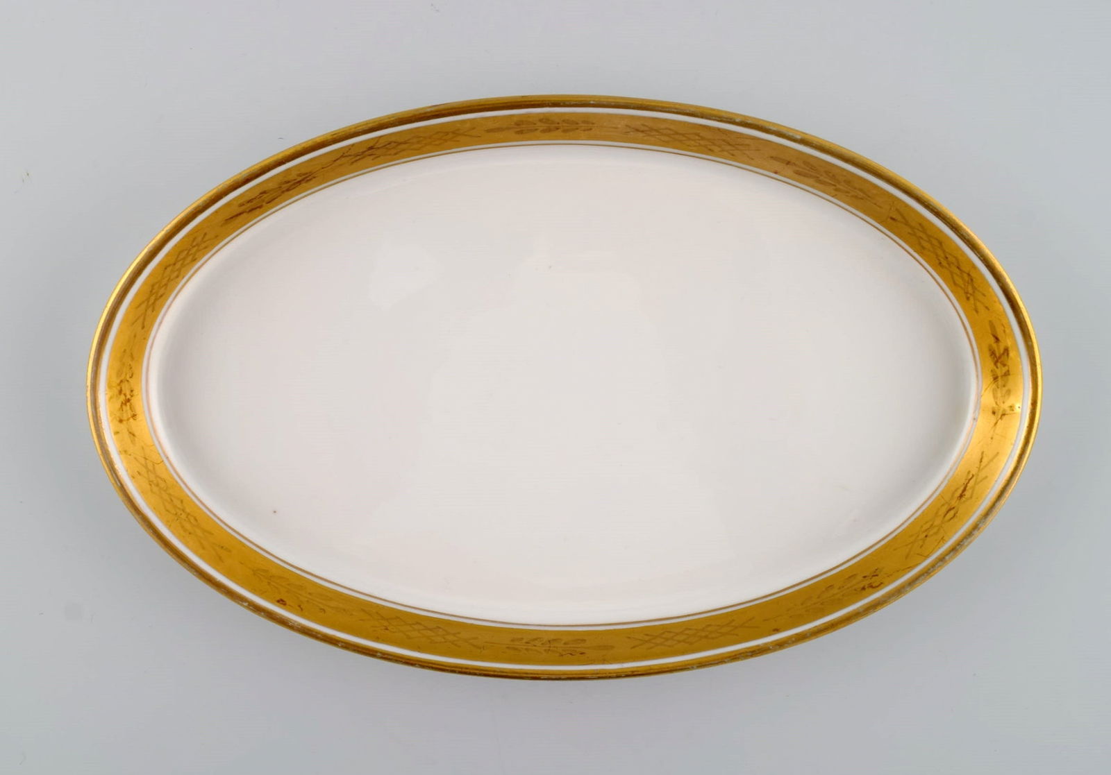 Royal Copenhagen service no. 607. Two oval porcelain dishes. Gold border with foliage. Model number - 2