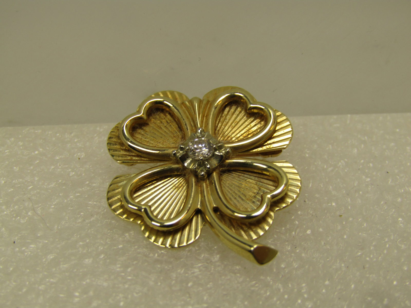 Vintage 14kt Diamond Four-Leaf Clover Brooch, 1960's-1970's, Signed: Vintage 14kt Diamond Four-Leaf Clover Brooch, 1960's-1970's, Signed with a T inside a diamond frame. The pin has an appx 3.4mm round diamond set in the center in an illusion setting giving the look it