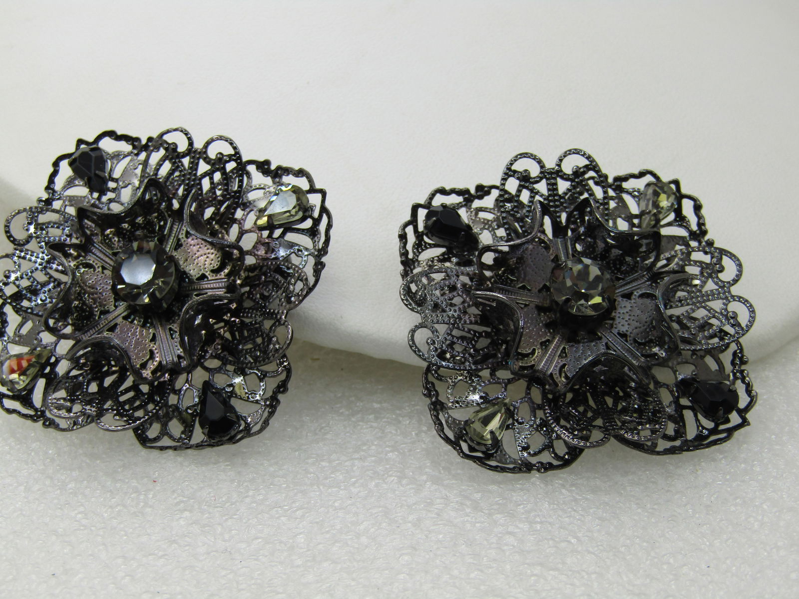 Pair Black Metal Filigree Rhinestone Brooches, Square, Smoky Stones, 1.75": Pair Black Metal Filigree Rhinestone Brooches, Square, Smoky Stones, 1.75", Tiered filigree brooches with a squae filigee base with turned edges and darker smoky and lighter smoky stones, pear shaped