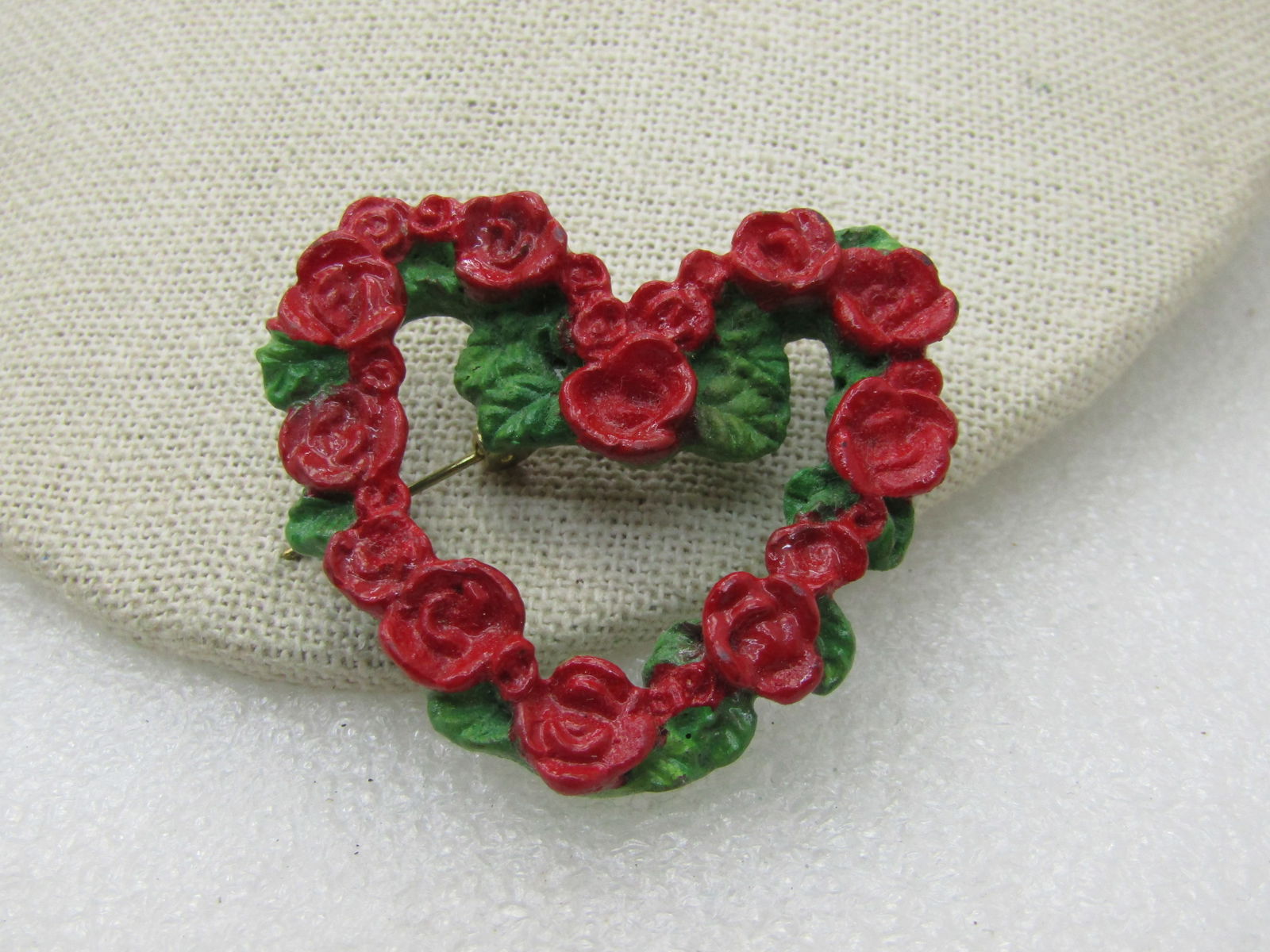 Vintage Red Rose Heart Wreath Brooch, Green Leaves, 2" by 1.5": Vintage Red Rose Heart Wreath Brooch, Green Leaves, 2" by 1.5", molded resin/plastic, very good condition. Not signed. With the colors of deep red and green, could work for Christmas too. (INV>